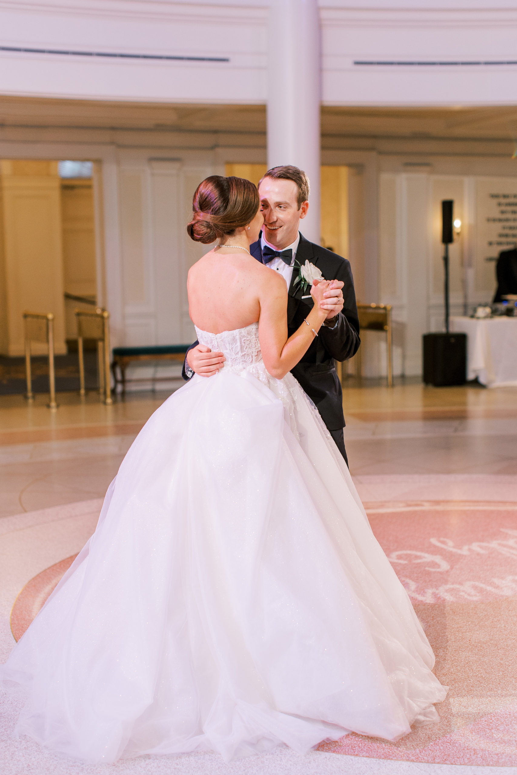 Bride and groom share a dance on dance floor 