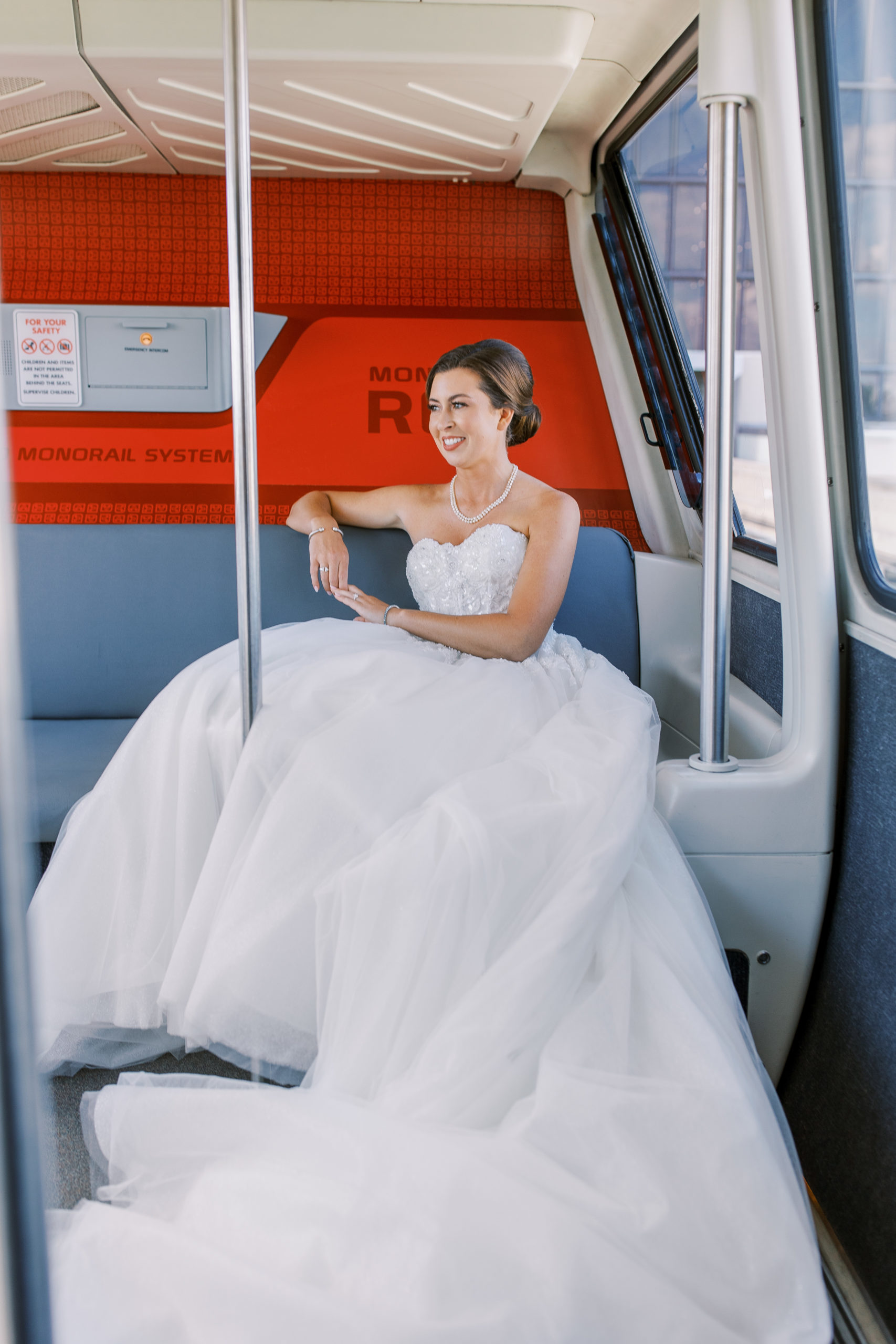 Bride sits in a monorail at Disney's Resort for a Romantic and Timeless Grand Floridian Wedding 
