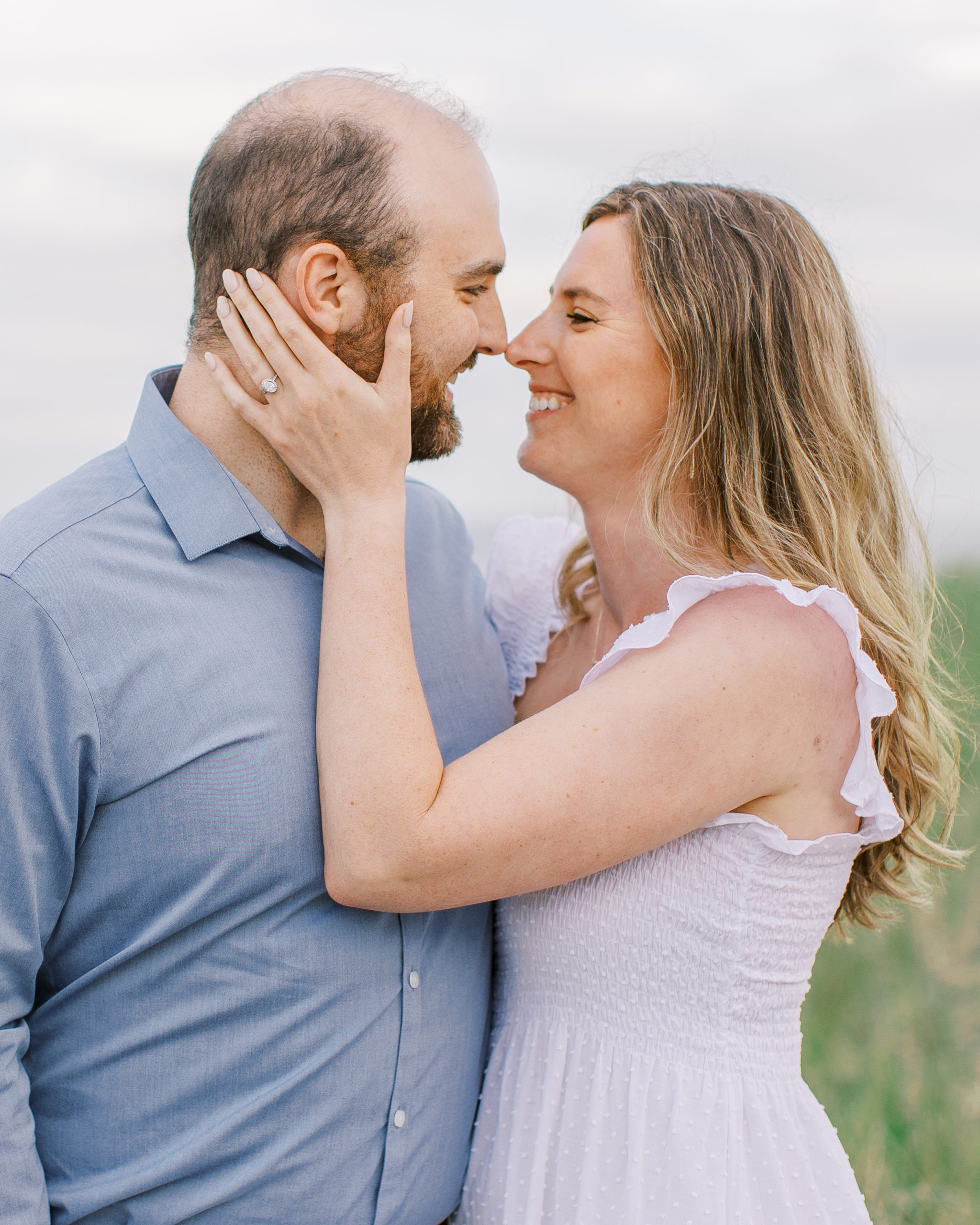 Up close couple smile and embrace for Coastal Maine Engagement Session 