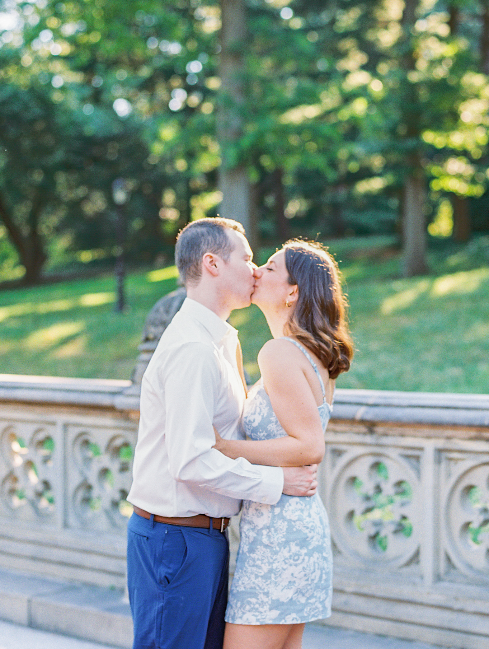 Couple embrace and kiss in park for Central Park Engagement Photos