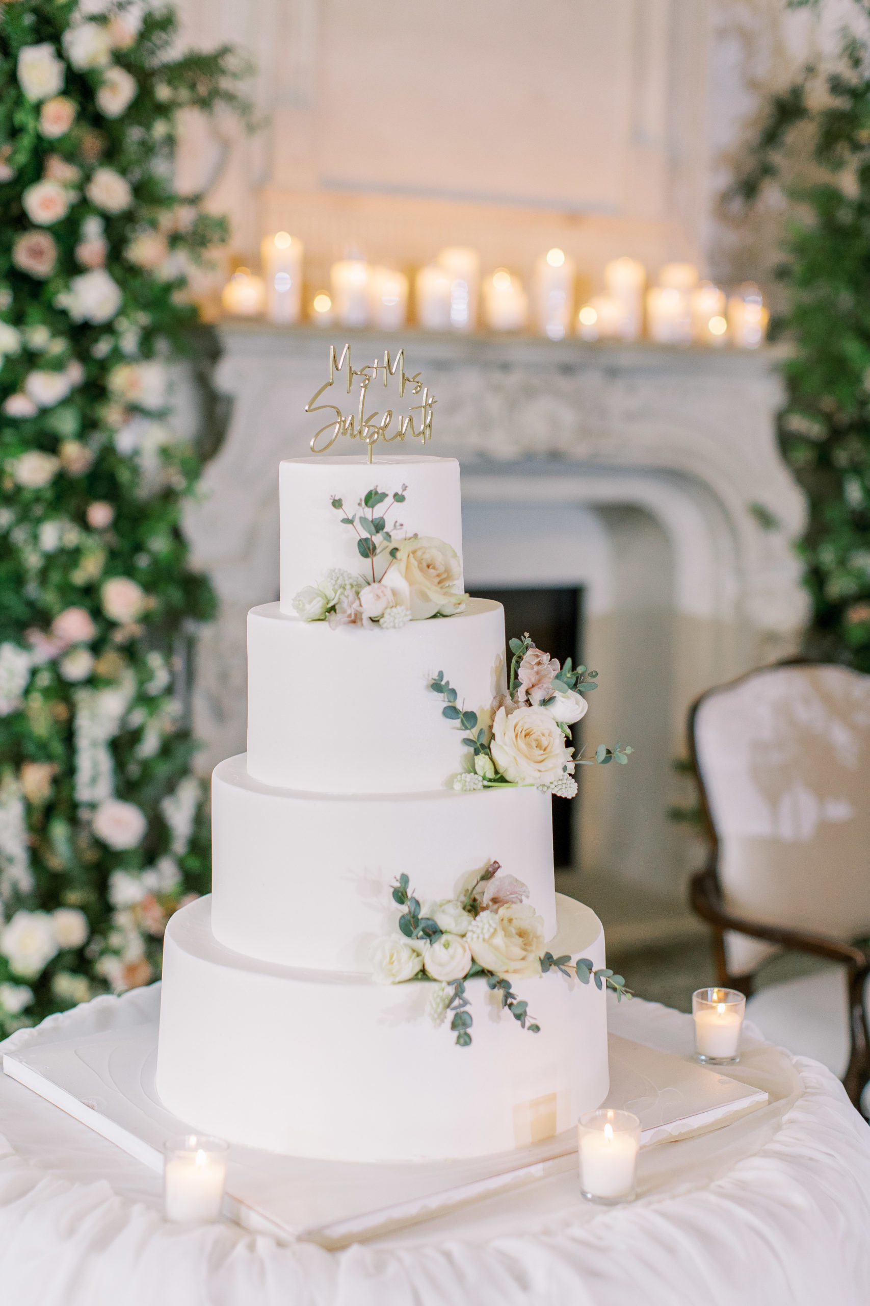 4-tiered white wedding cake with ivory and peach roses at a Romantic Park Chateau Wedding Photography
