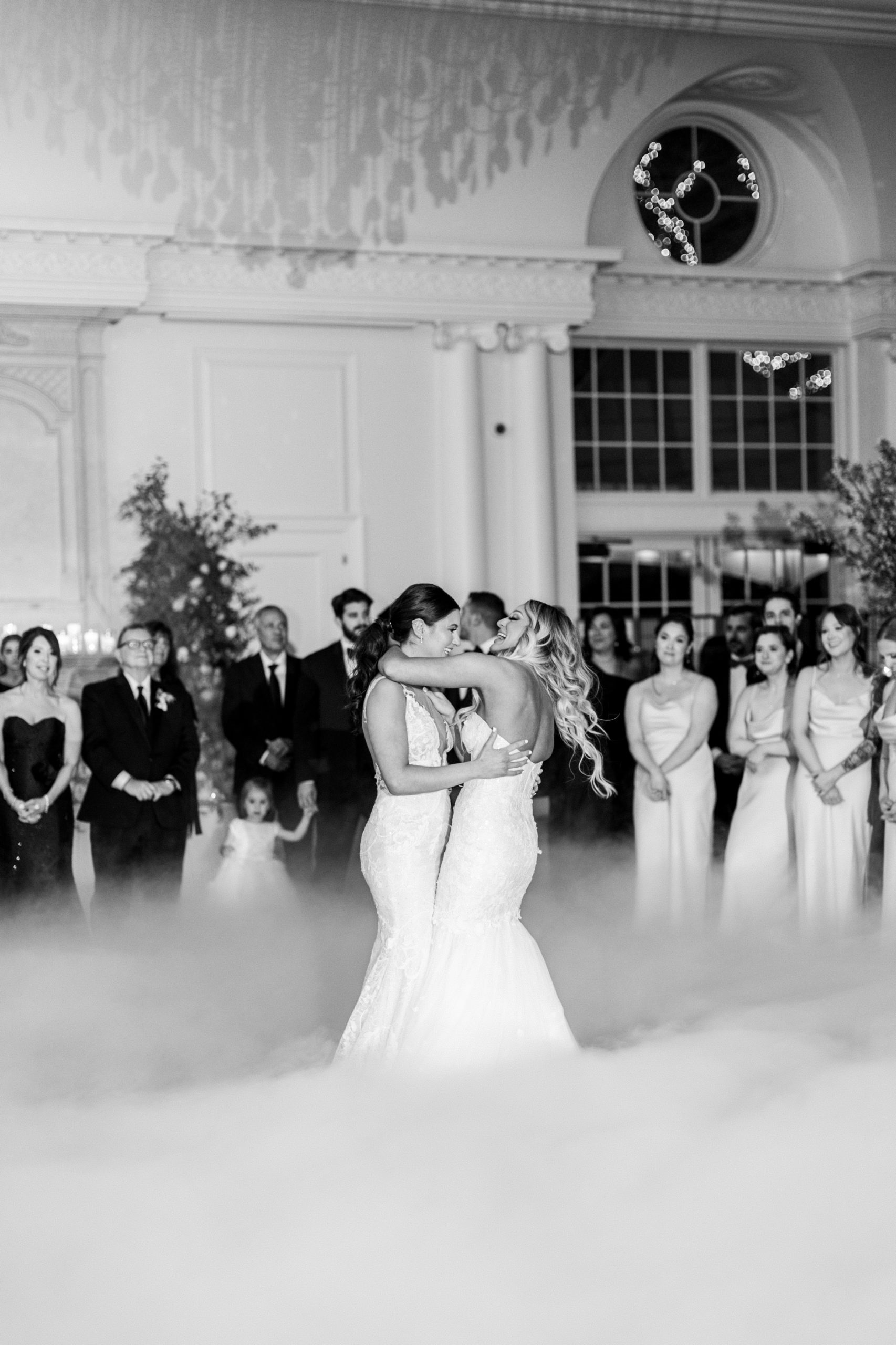 Brides share a dance and smile at wedding reception for a Romantic Park Chateau Wedding Photography