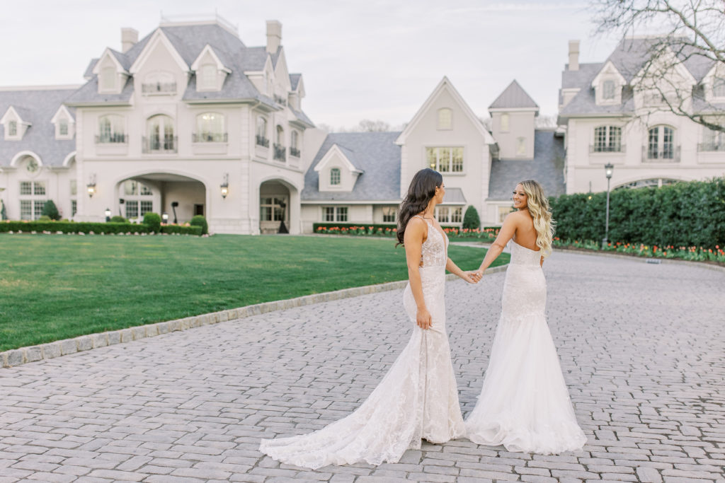 Brides walk and hold hands on driveway of Chateau for a Romantic Park Chateau Wedding Photography