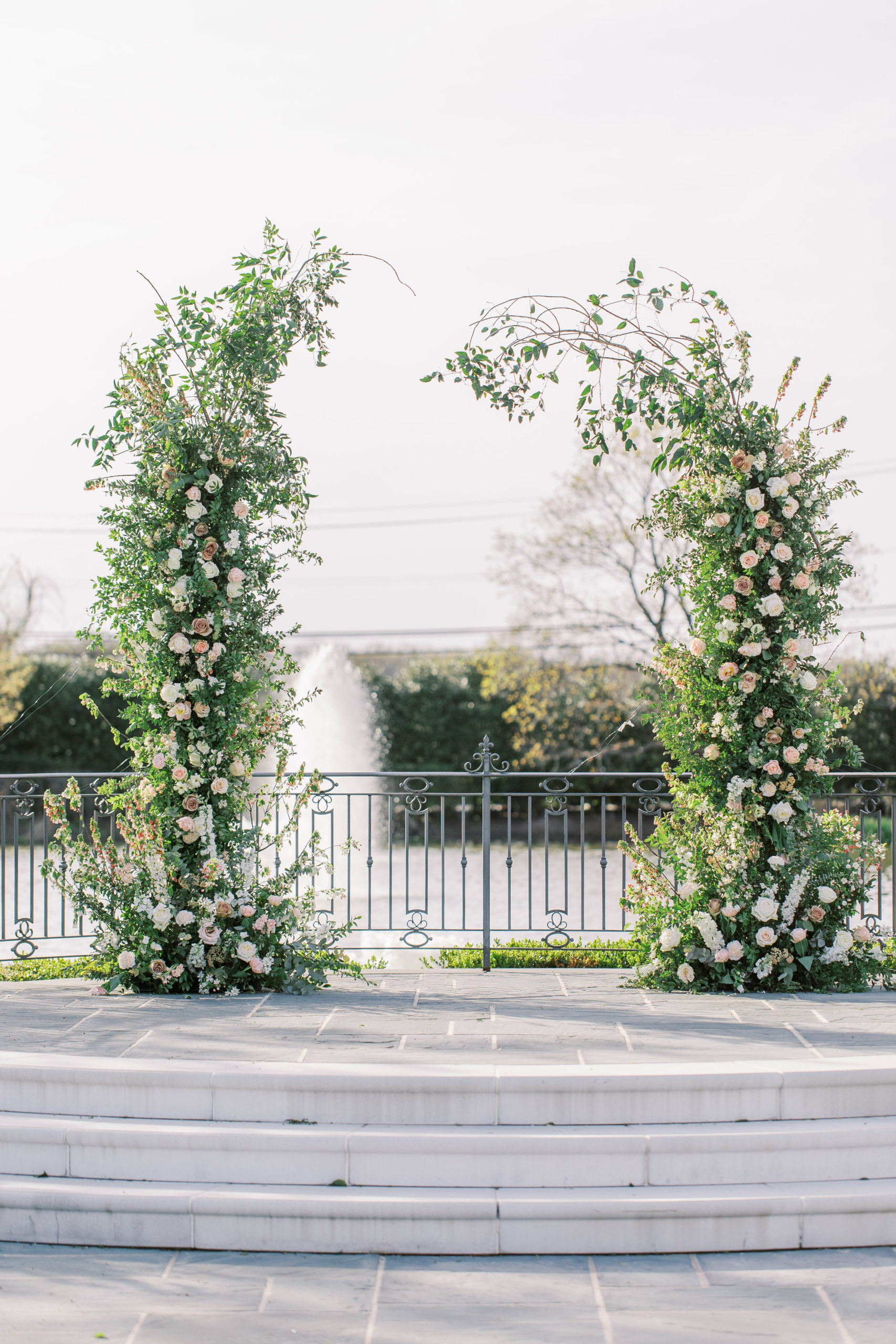 White and peach rose arch for wedding ceremony at a Romantic Park Chateau Wedding Photography
