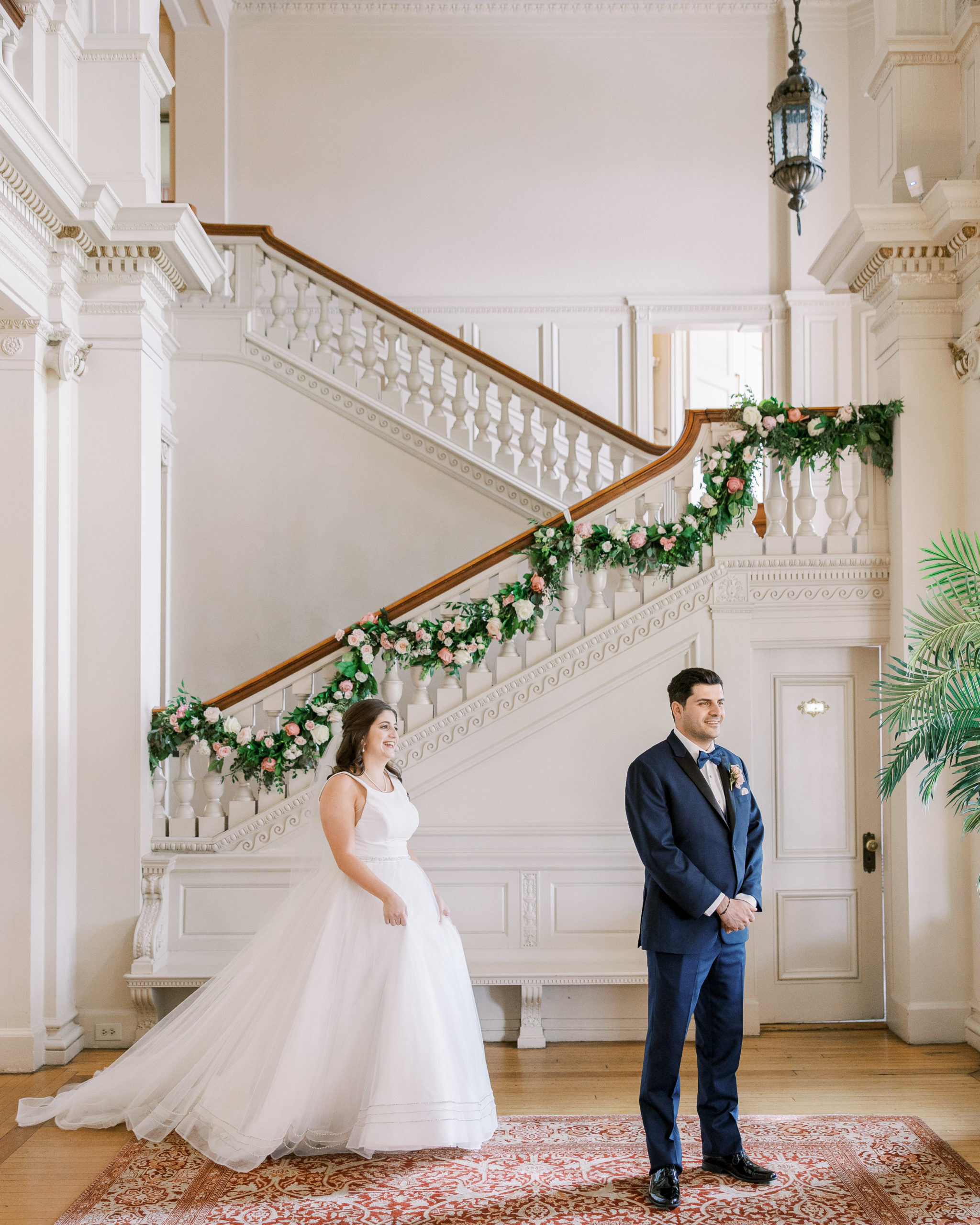 Bride and Groom before the first look in great hall with grand staircase and rose garland for Cairnwood Estate Wedding Photography