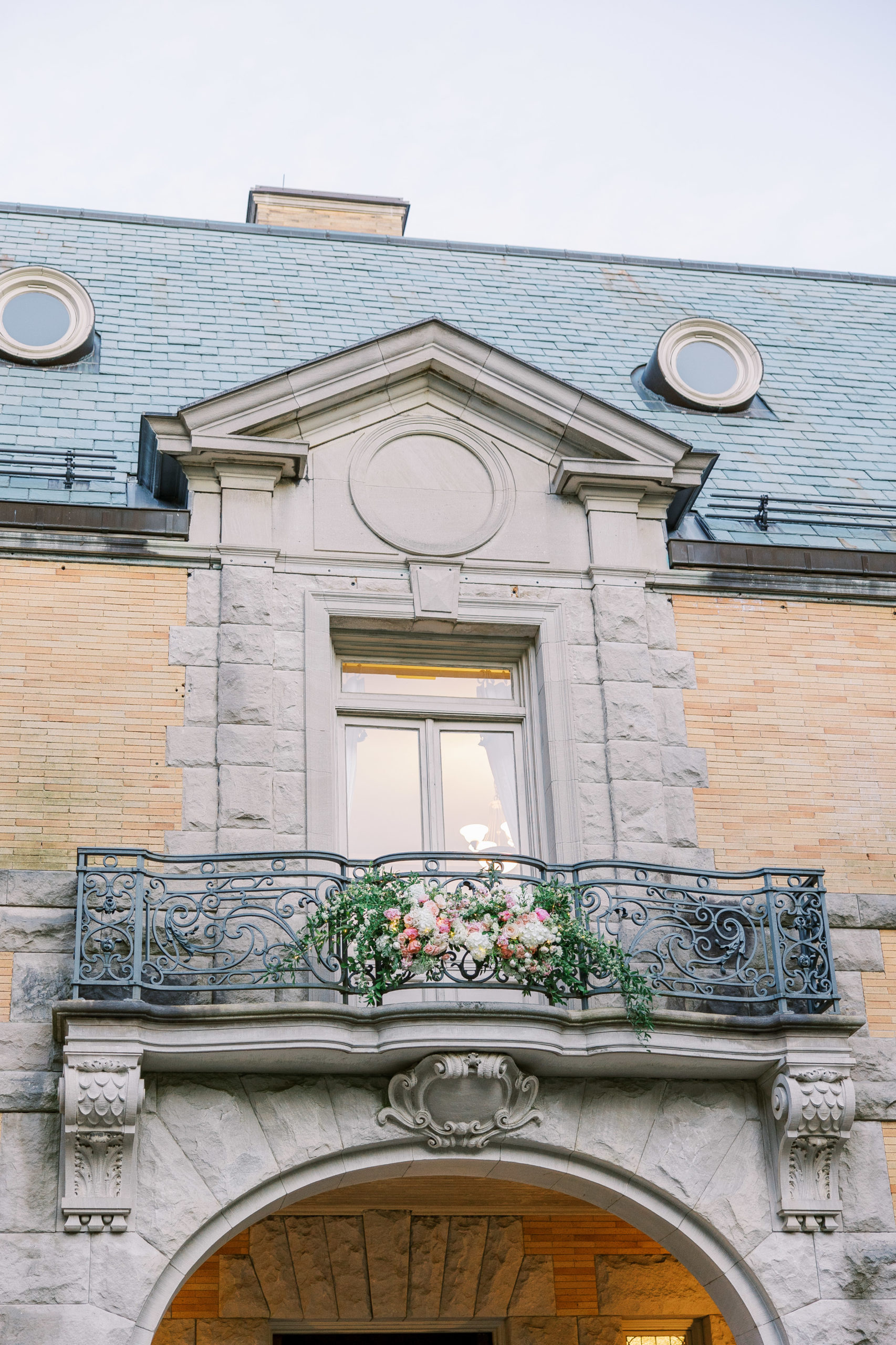 Balcony with roses and arch made of limestone and brick for Cairnwood Estate Wedding Photography
