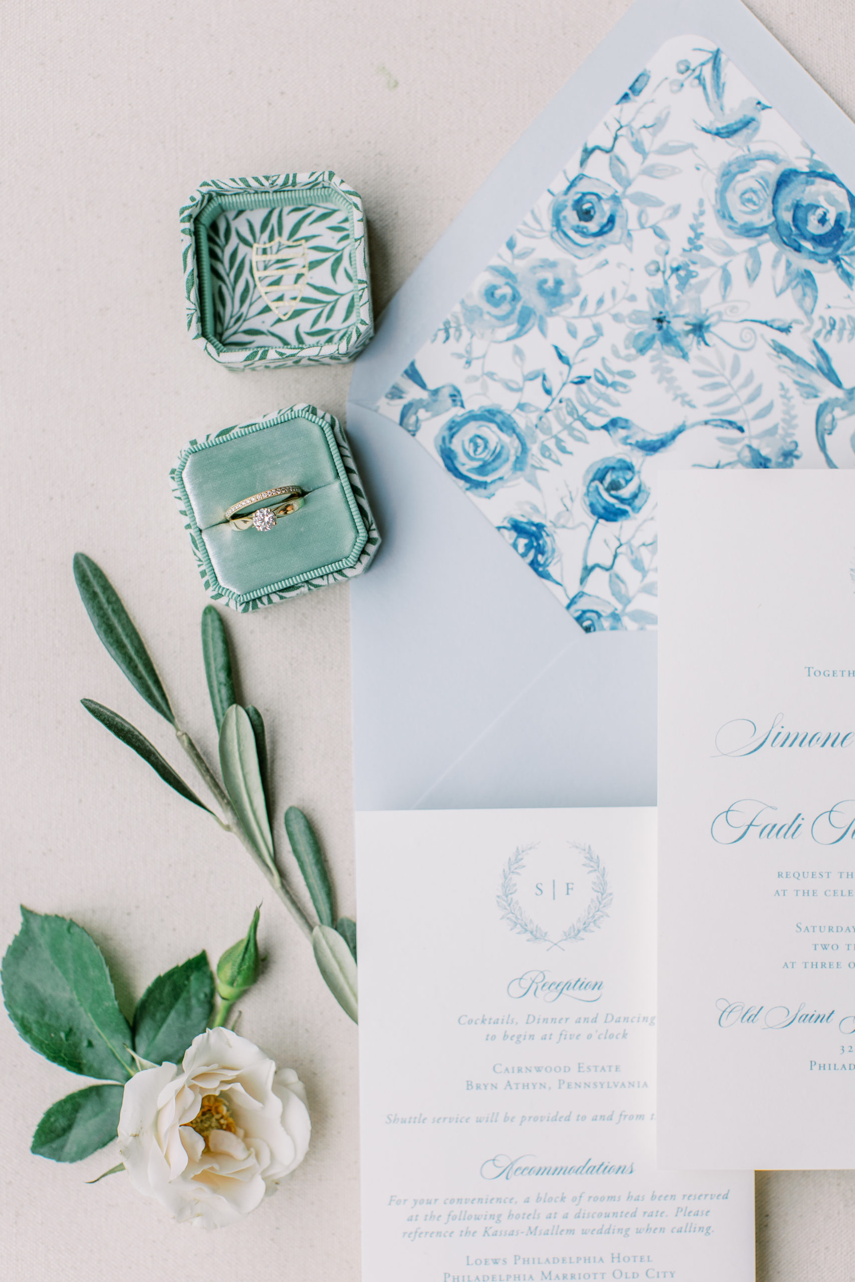 Light blue and white wedding invitations with white rose and ring box at Cairnwood Estate Wedding Photography