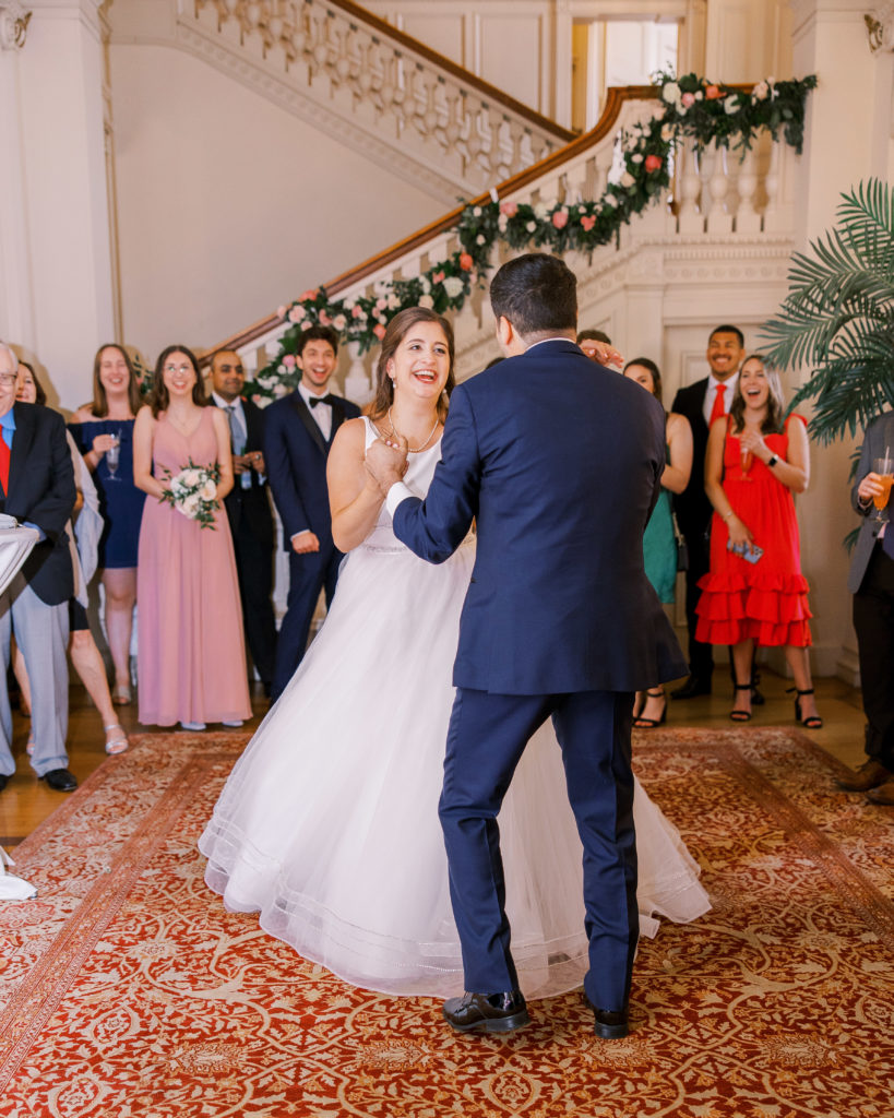 Bride and groom dance at wedding reception with family and friends watching and smiling at Cairnwood Estate Wedding Photography