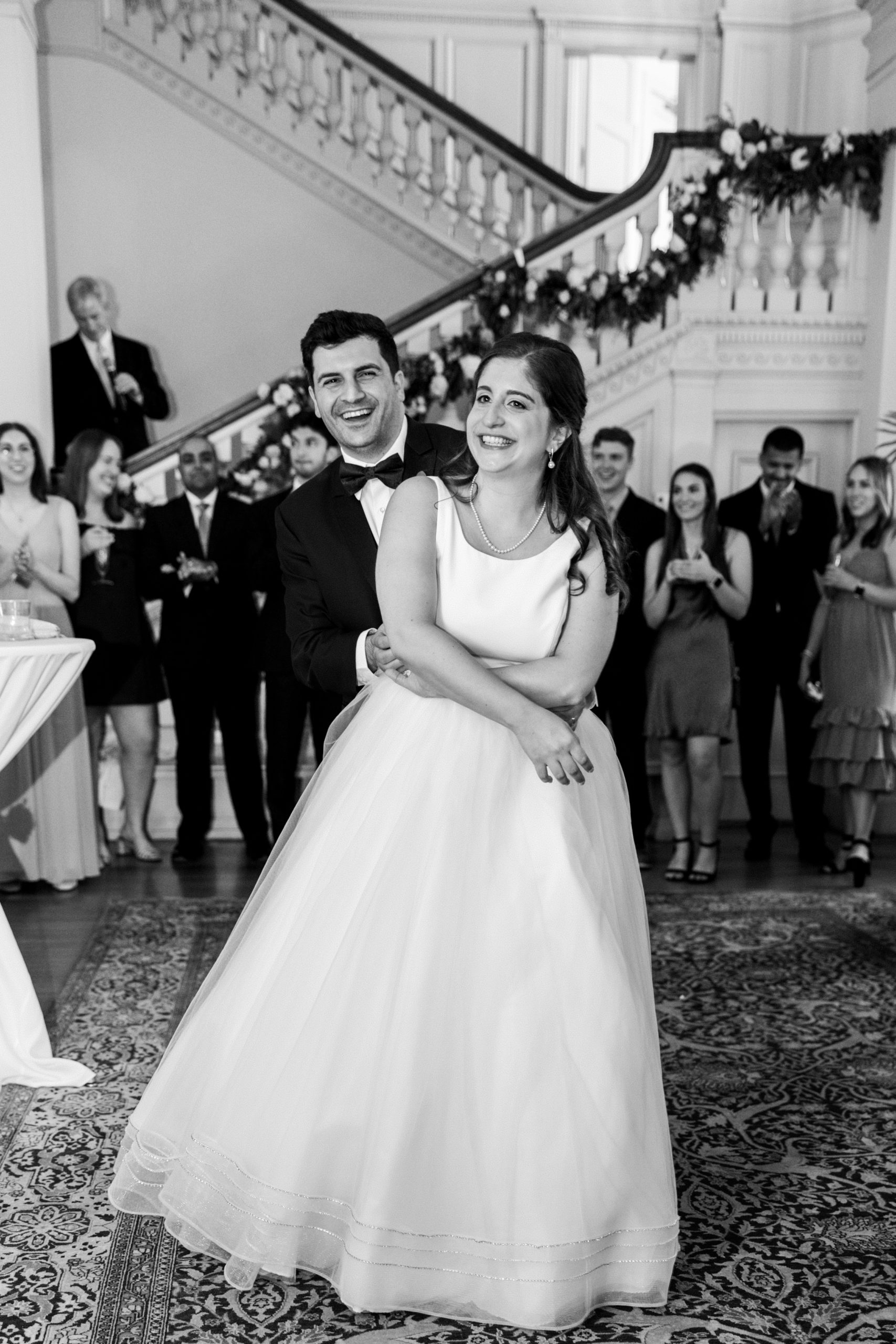 Groom embraces bride and they smile at wedding reception for Cairnwood Estate Wedding Photography