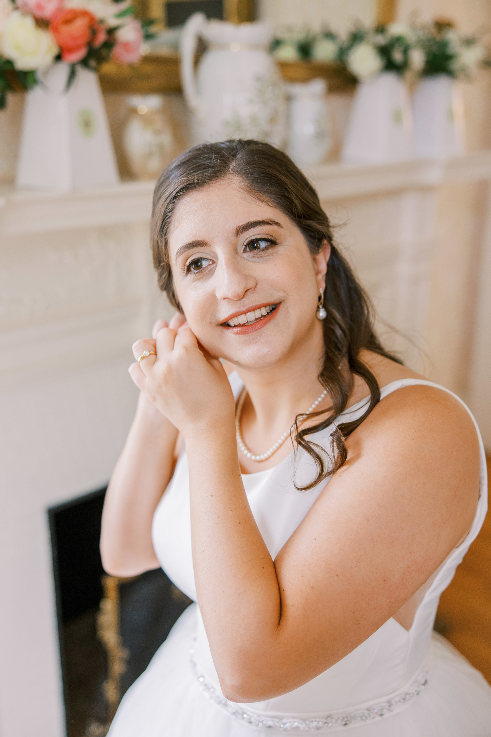 Bride puts earrings on and smiles at Cairnwood Estate Wedding Photography