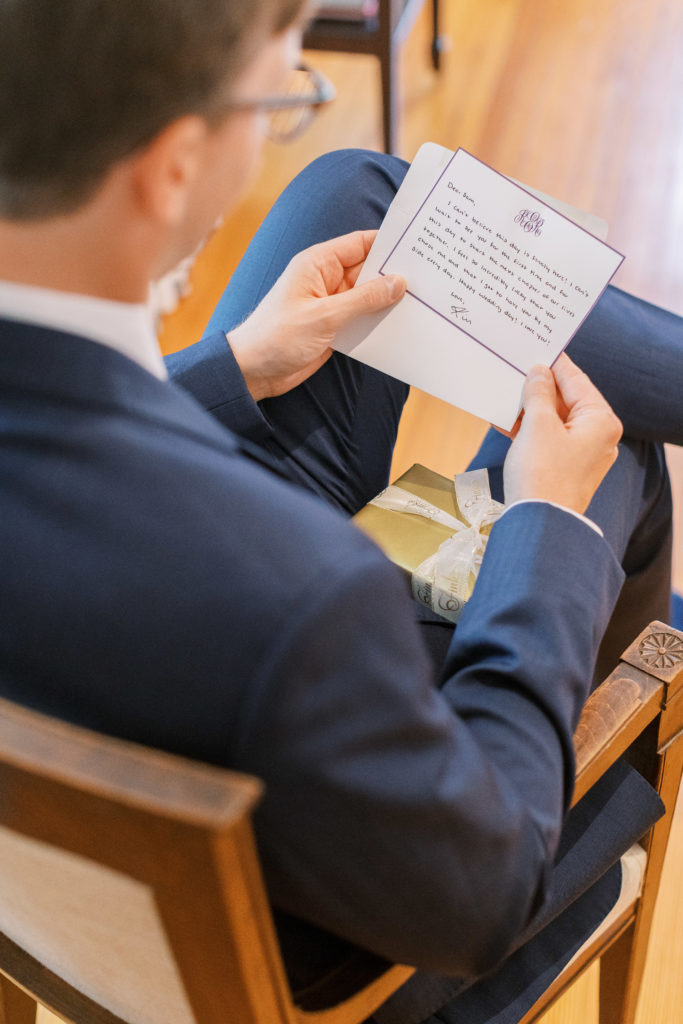 Groom sits and reads letter from bride 
