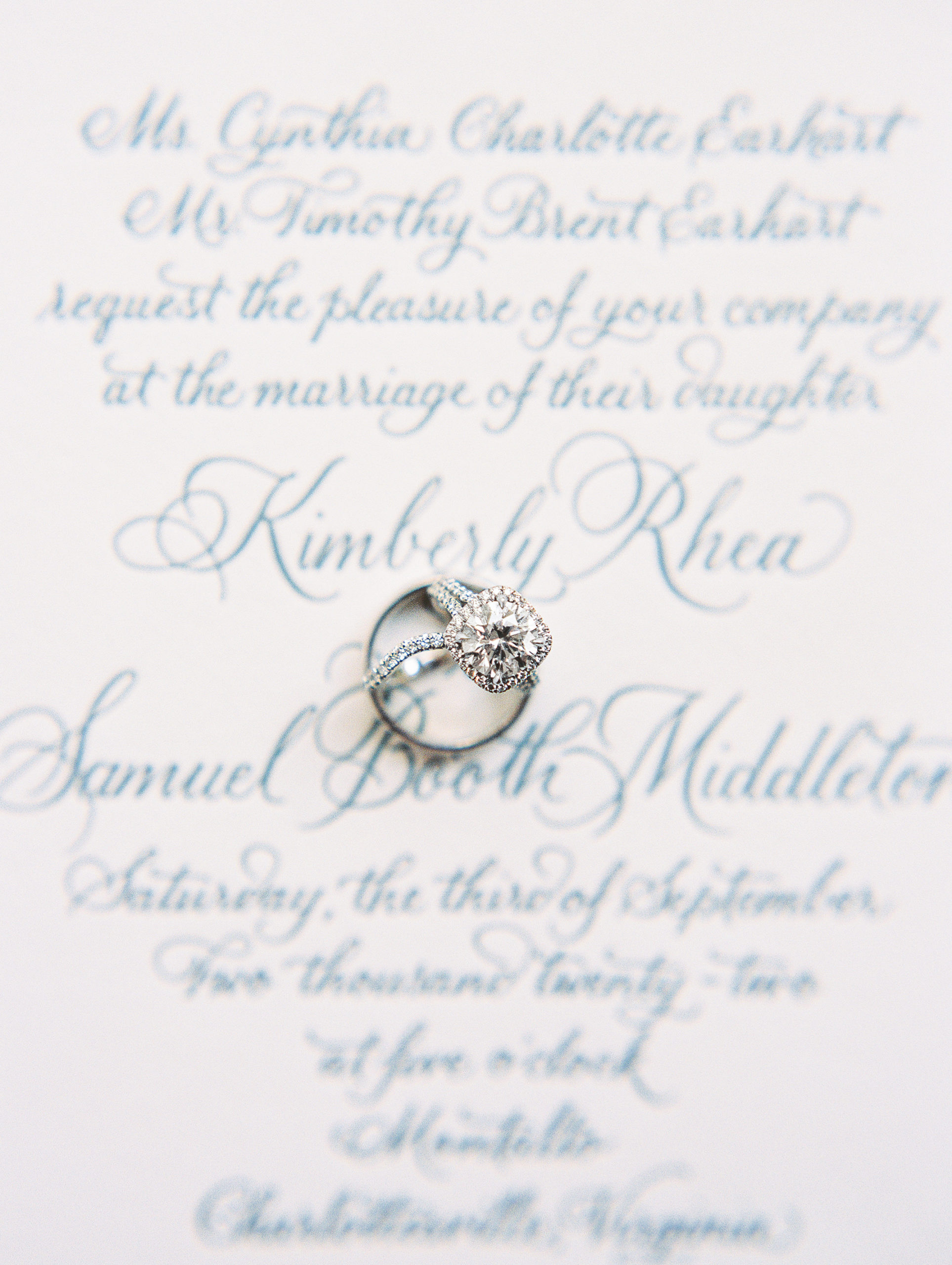 Rings set on top of delicate calligraphy invitations for Charlottesville Wedding Photography
