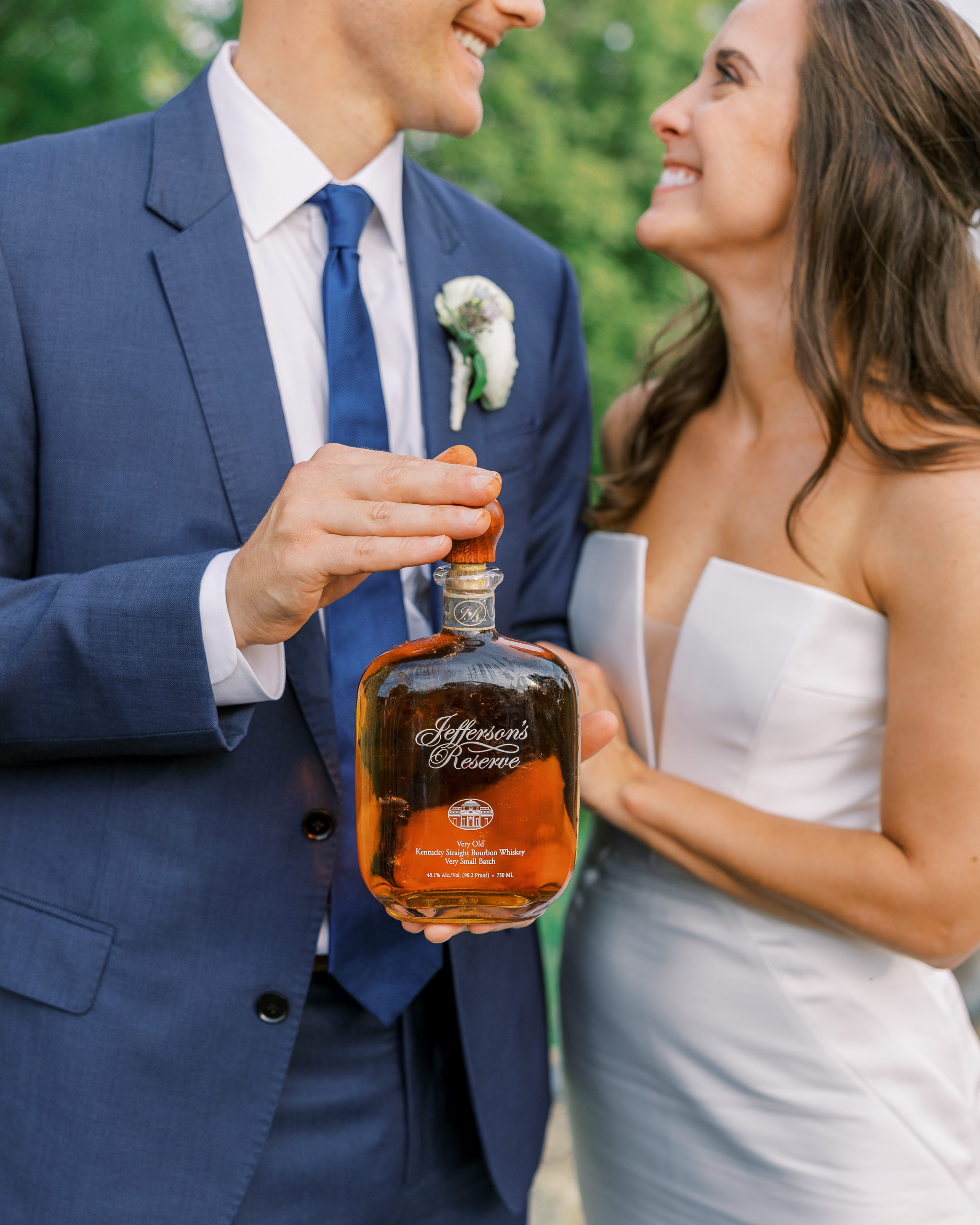 Bride and groom hold Jefferson's Reserve whiskey 