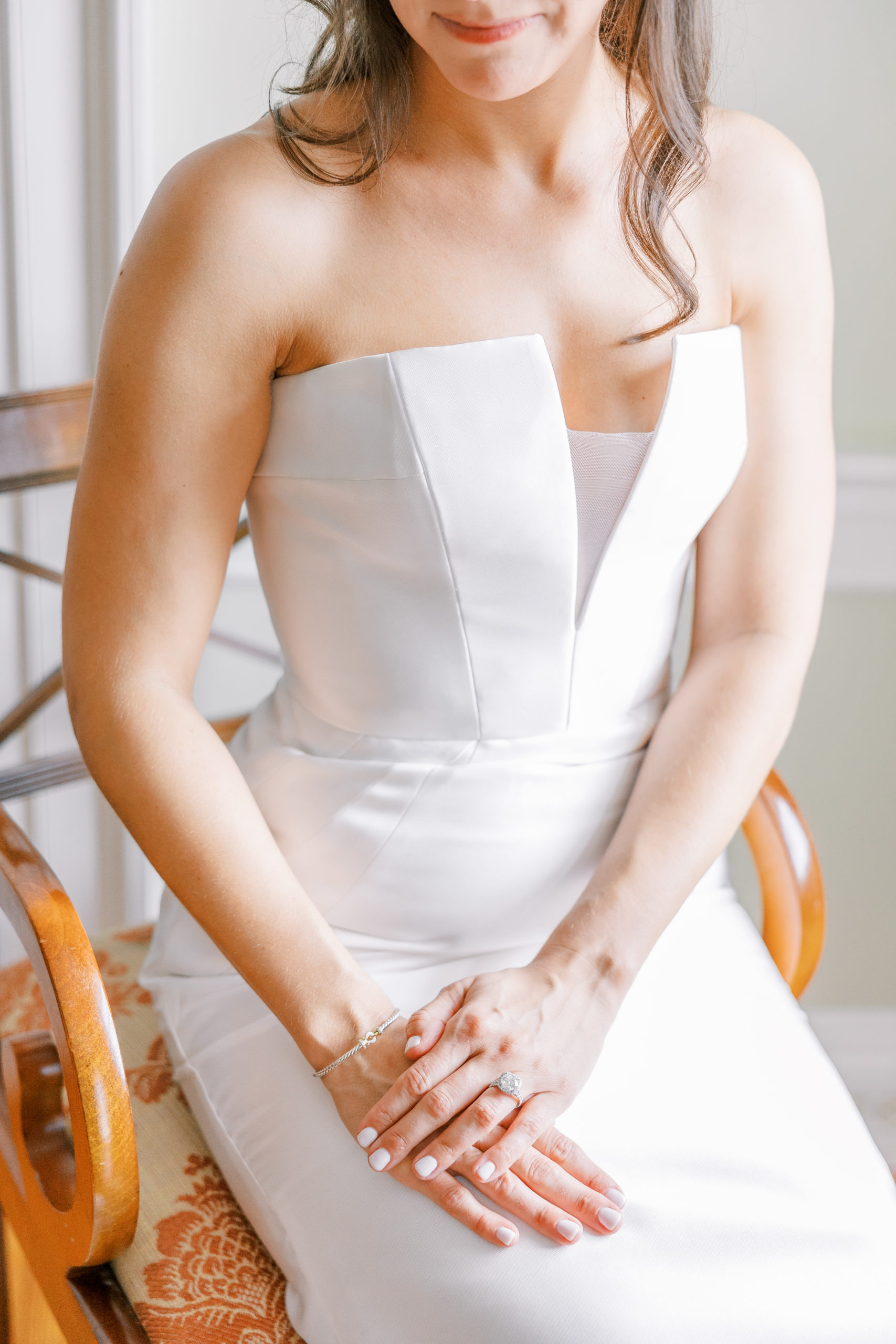 Bride sitting in chair displaying beautiful ring and bracelet for Charlottesville Wedding Photography
