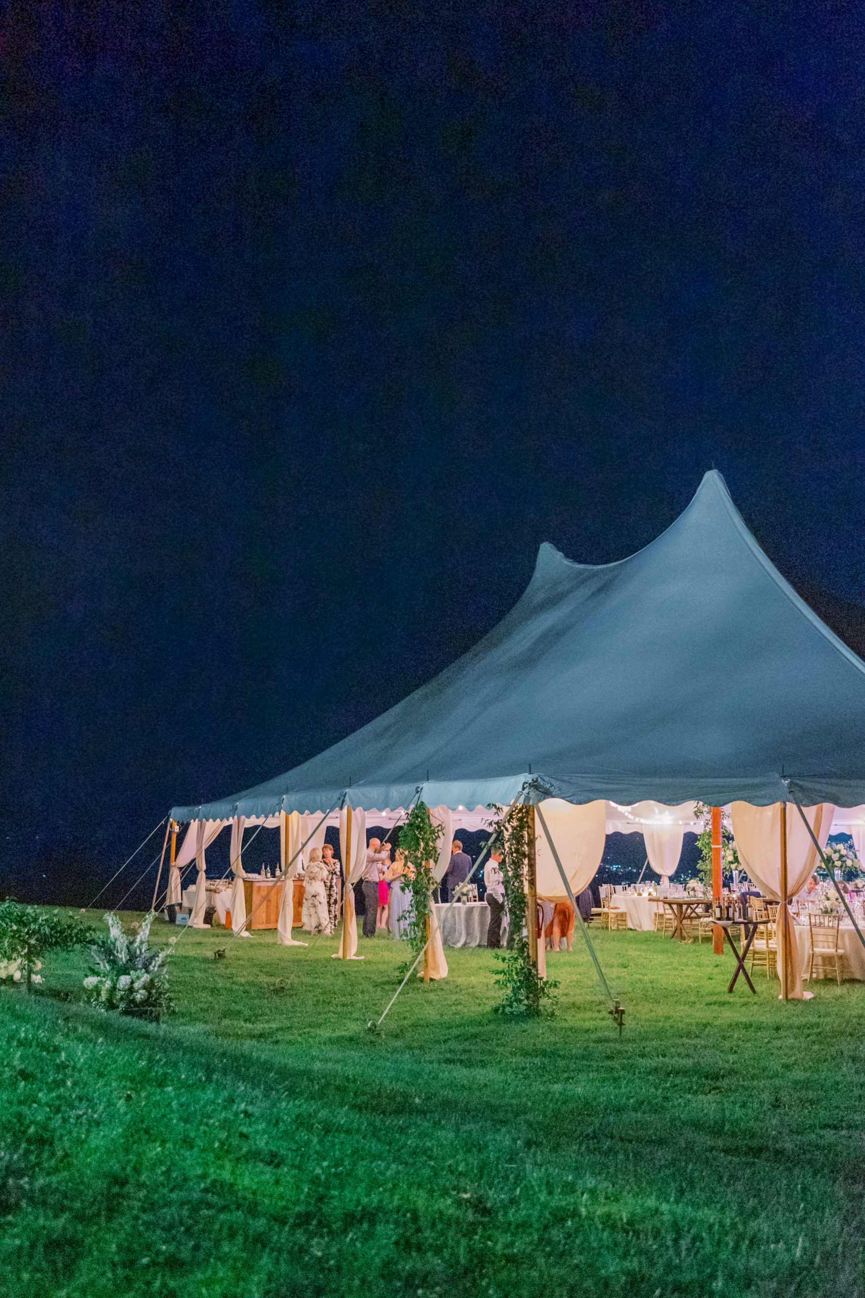 Wedding reception underneath white tent at nighttime for Charlottesville Wedding Photography
