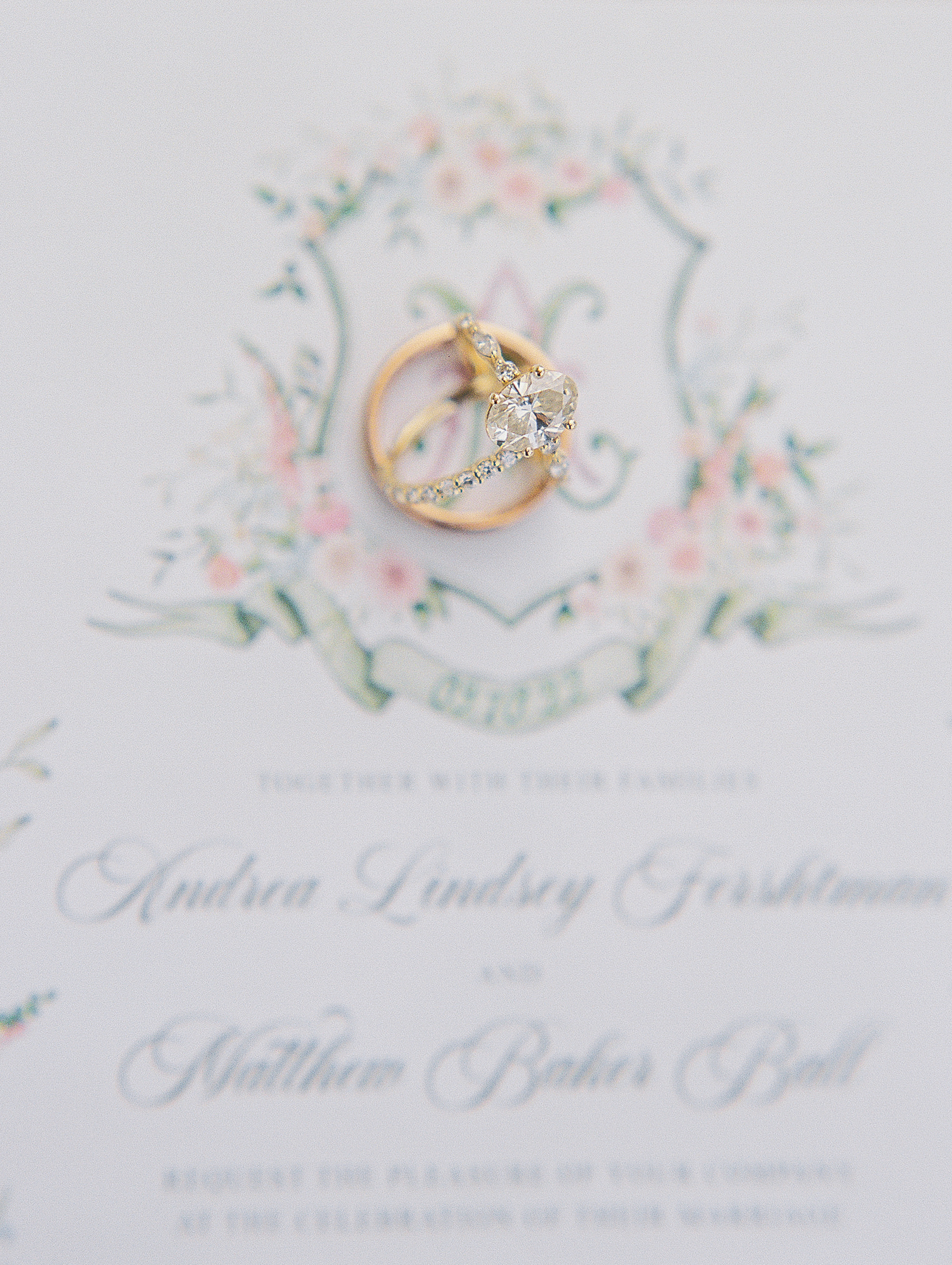 Display of wedding rings atop wedding invitations for New Hampshire Wedding Photography