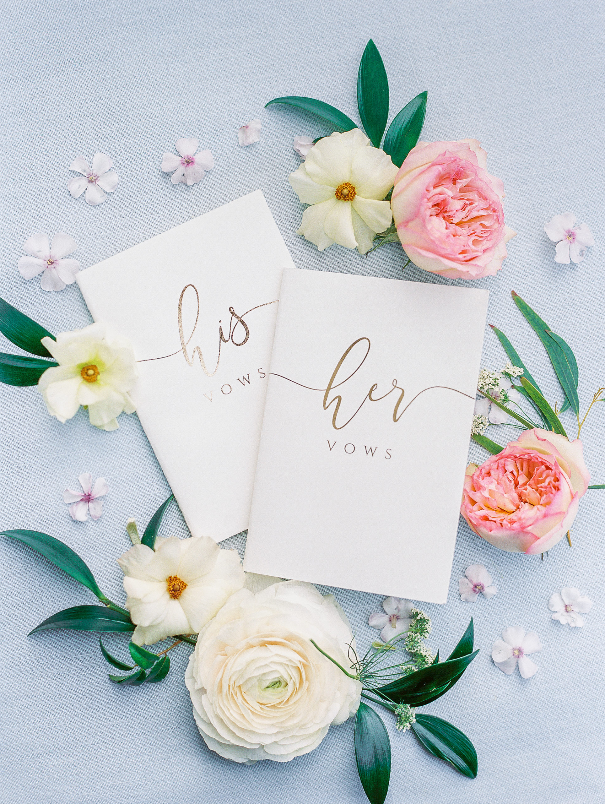 His and Her vows of gold calligraphy and white and pink flowers for New Hampshire Wedding Photography