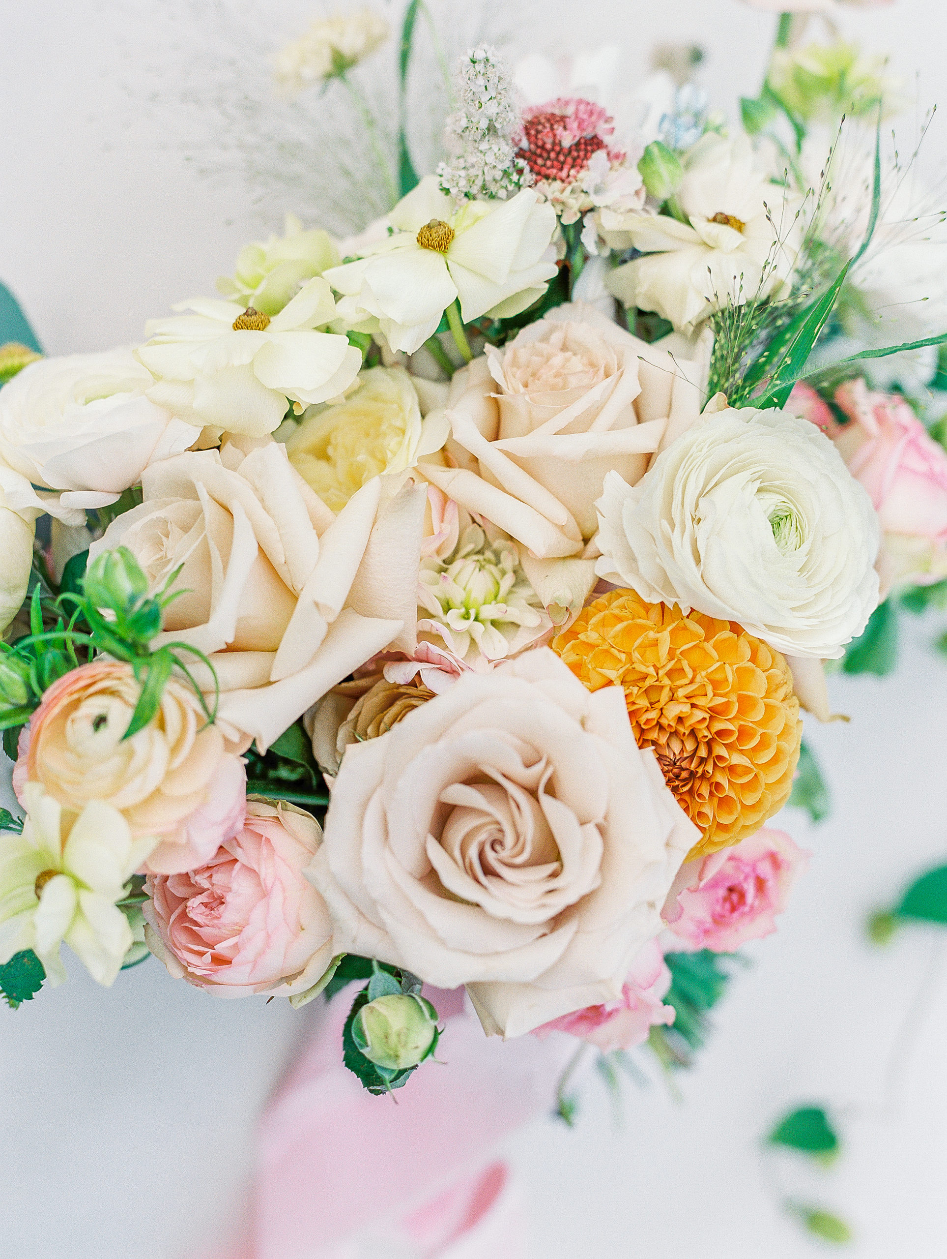 Up close view of cream, pink and beige roses in bride's bouquet for New Hampshire Wedding Photography