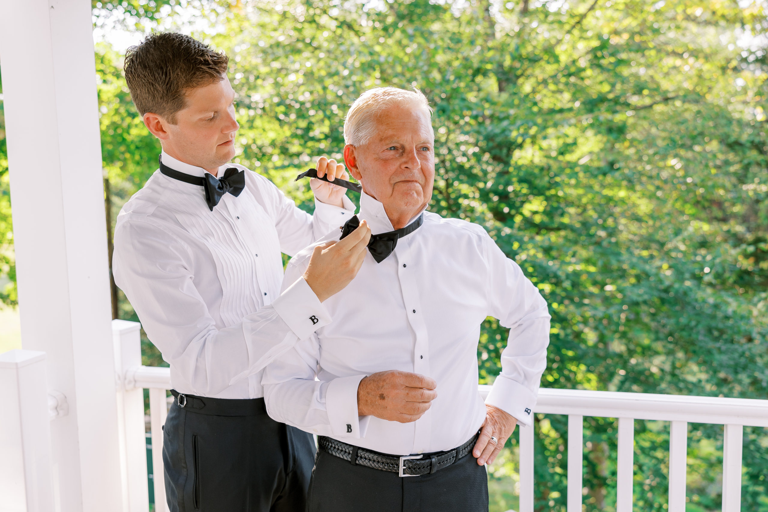 Groom puts black bowtie on father for New Hampshire Wedding Photography