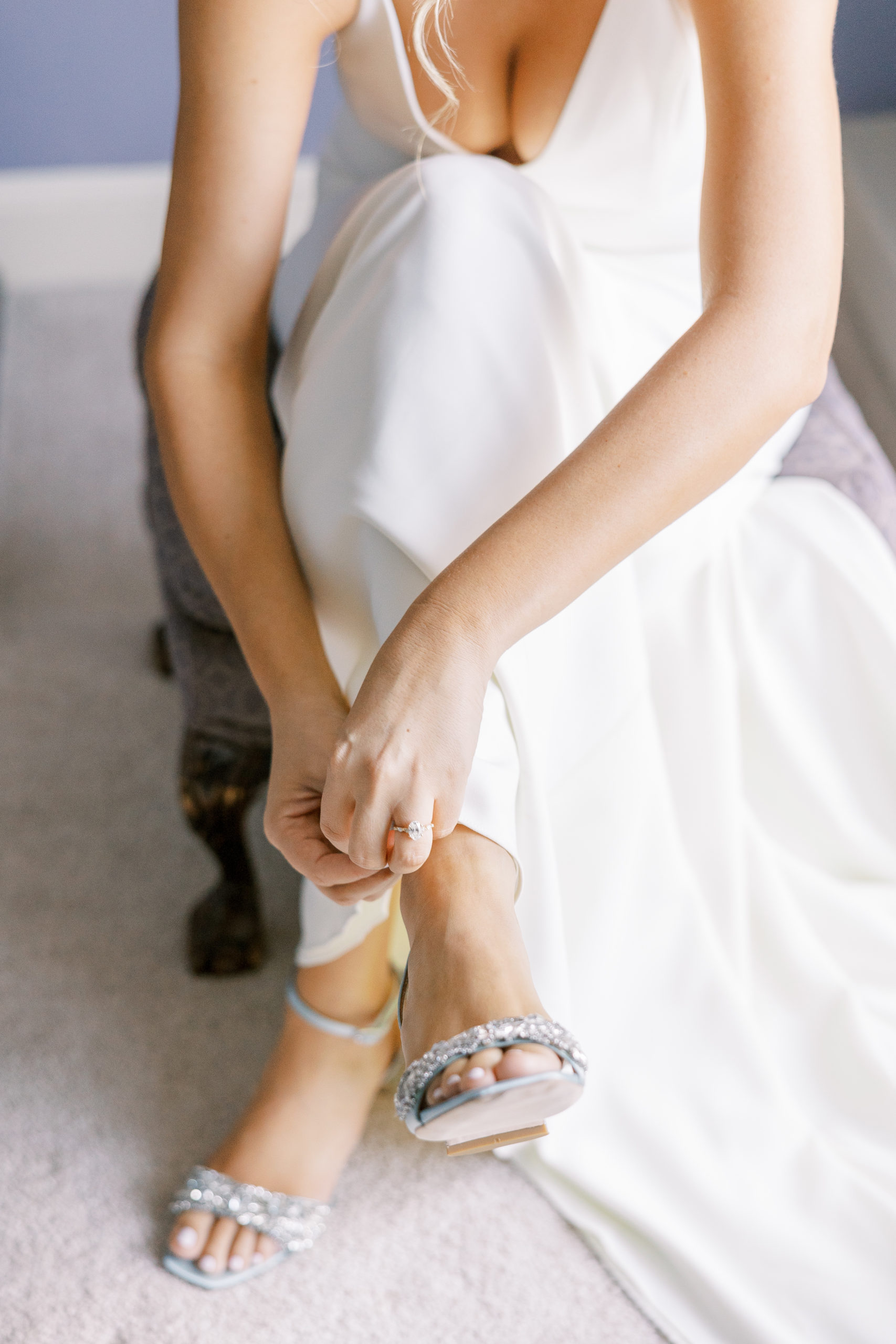 Bride puts on sparkled wedding shoes in dress for New Hampshire Wedding Photography