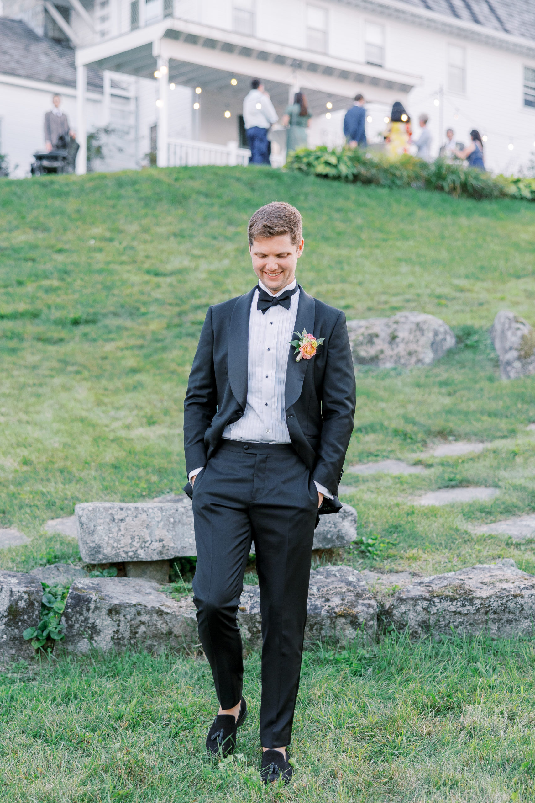 Groom smiles and walks outside of reception area for New Hampshire Wedding Photography