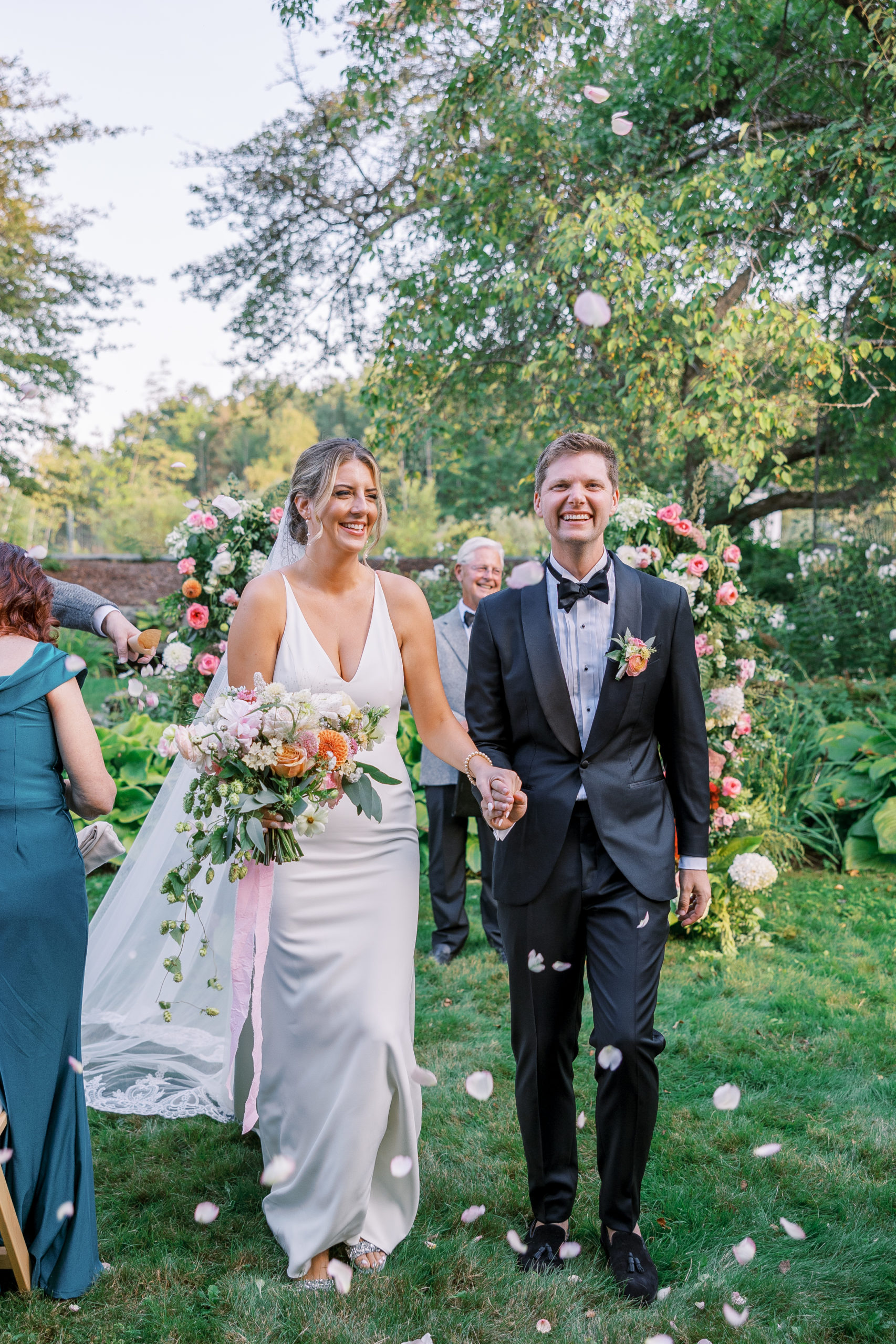 Bride and groom smile and hold hands after just being married for New Hampshire Wedding Photography