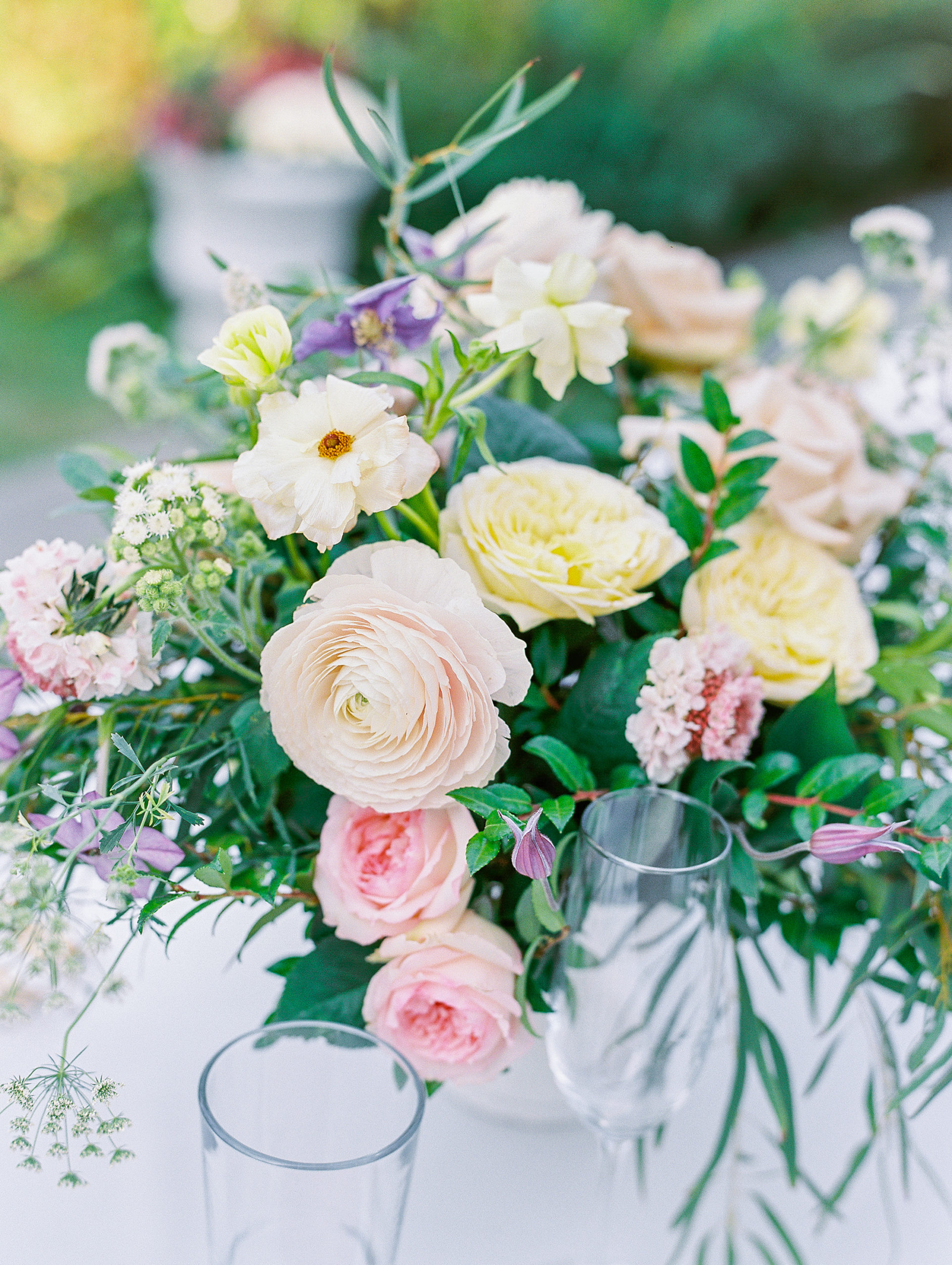Up close view of reception flower bouquets that are yellow, light pink, and cream 
