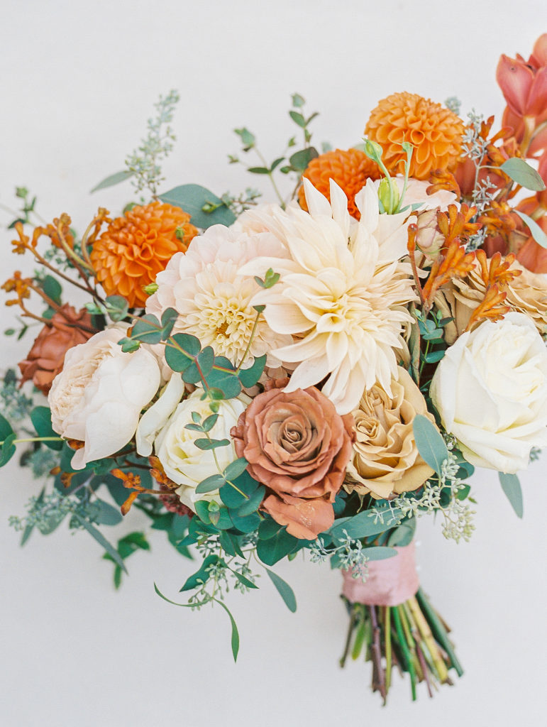 Wedding bouquet with cream, orange, and blush colored flowers for Terrain at Styer's Wedding