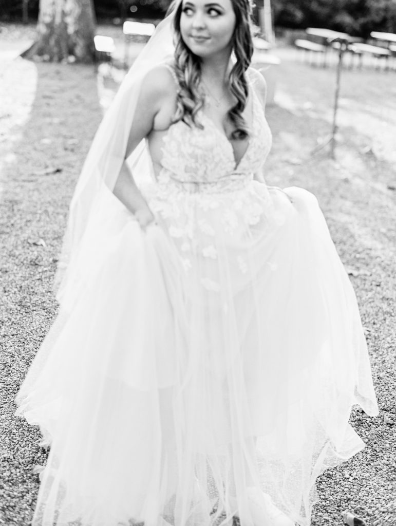 Bride smiles and looks away as she walks for Terrain Glen Mills Wedding