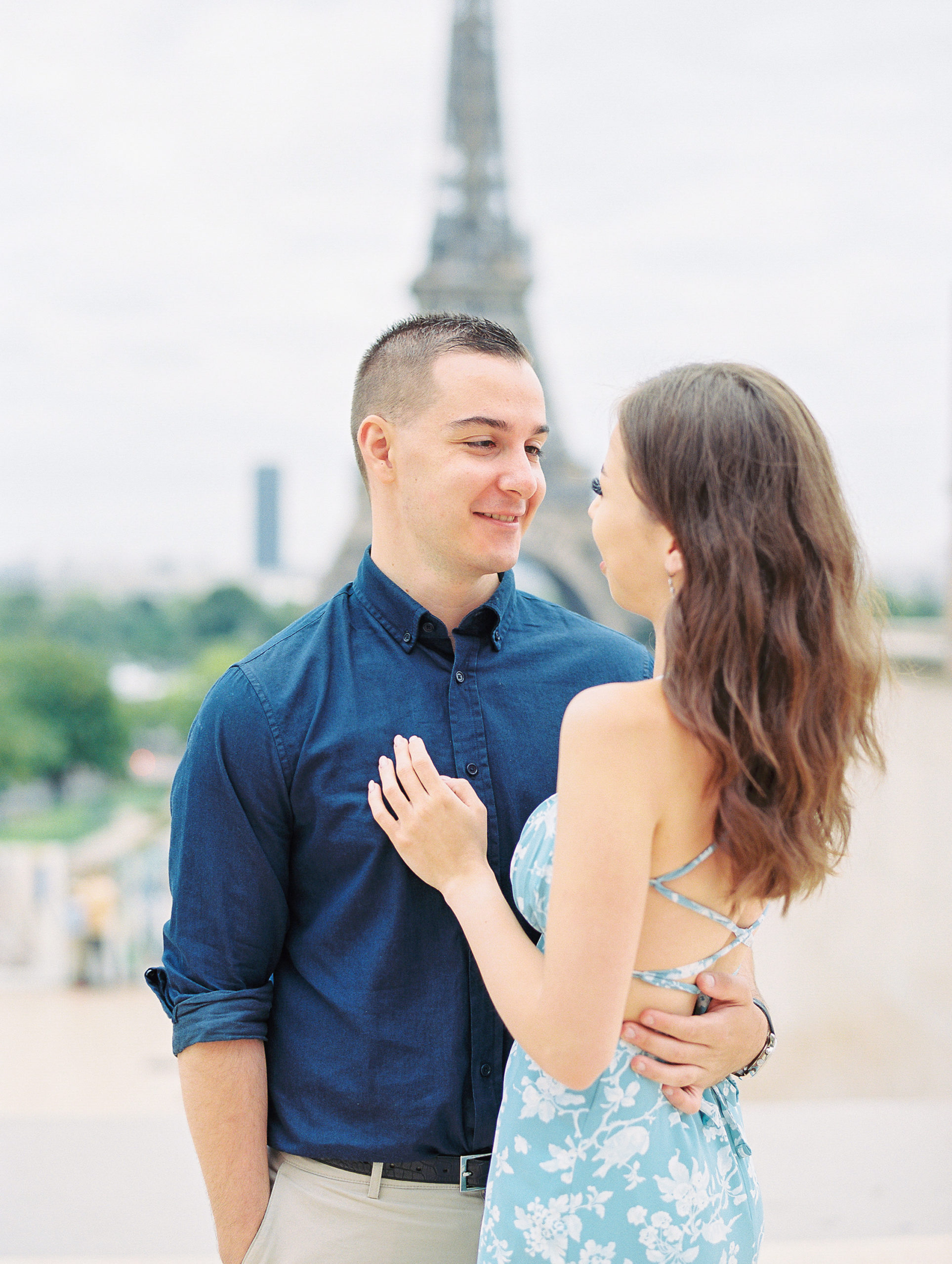 Couple embraces and smiles into each other's eyes for Paris Film Photographer