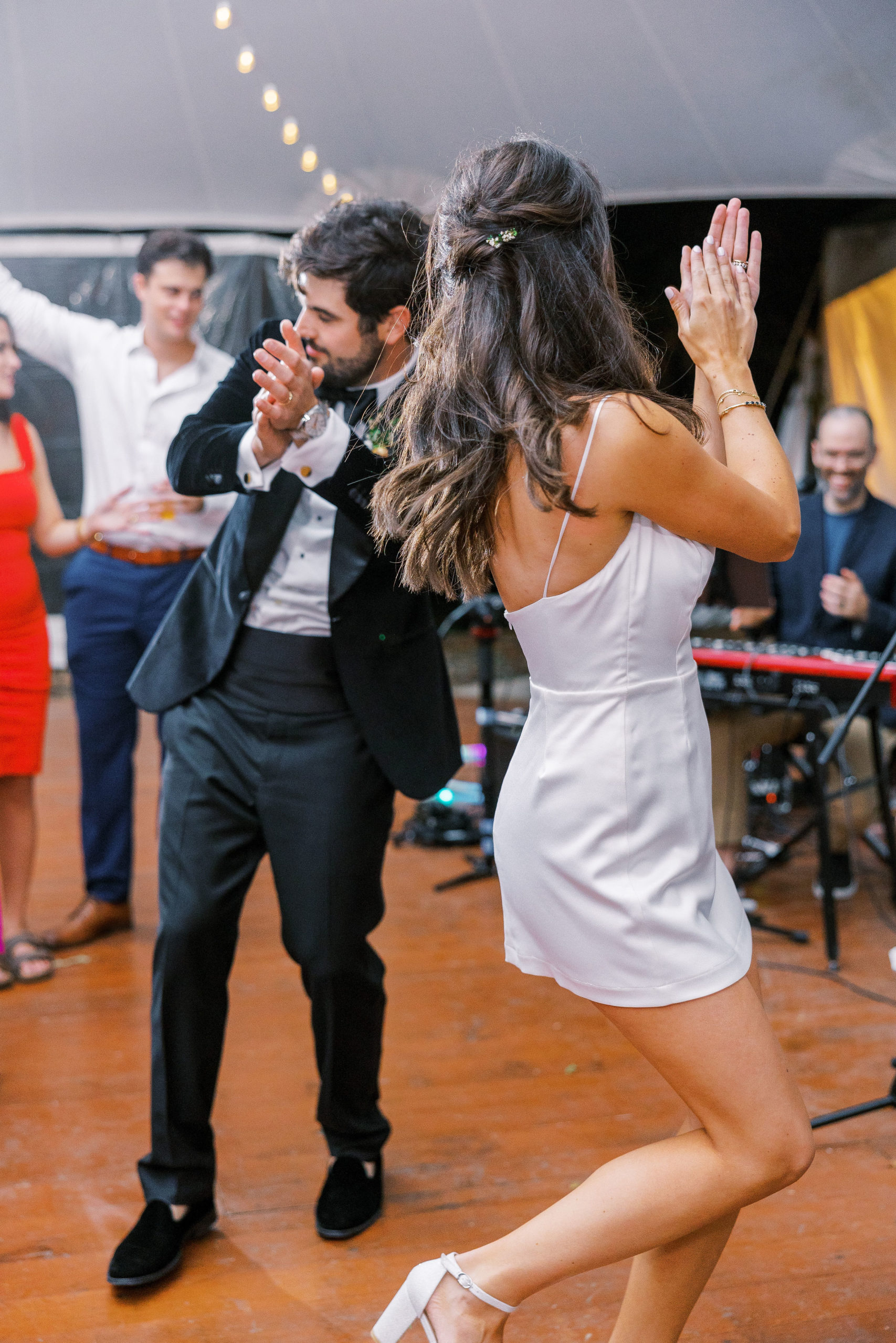 Bride and groom clap and dance on dance floor during wedding reception for Clifton wedding photography