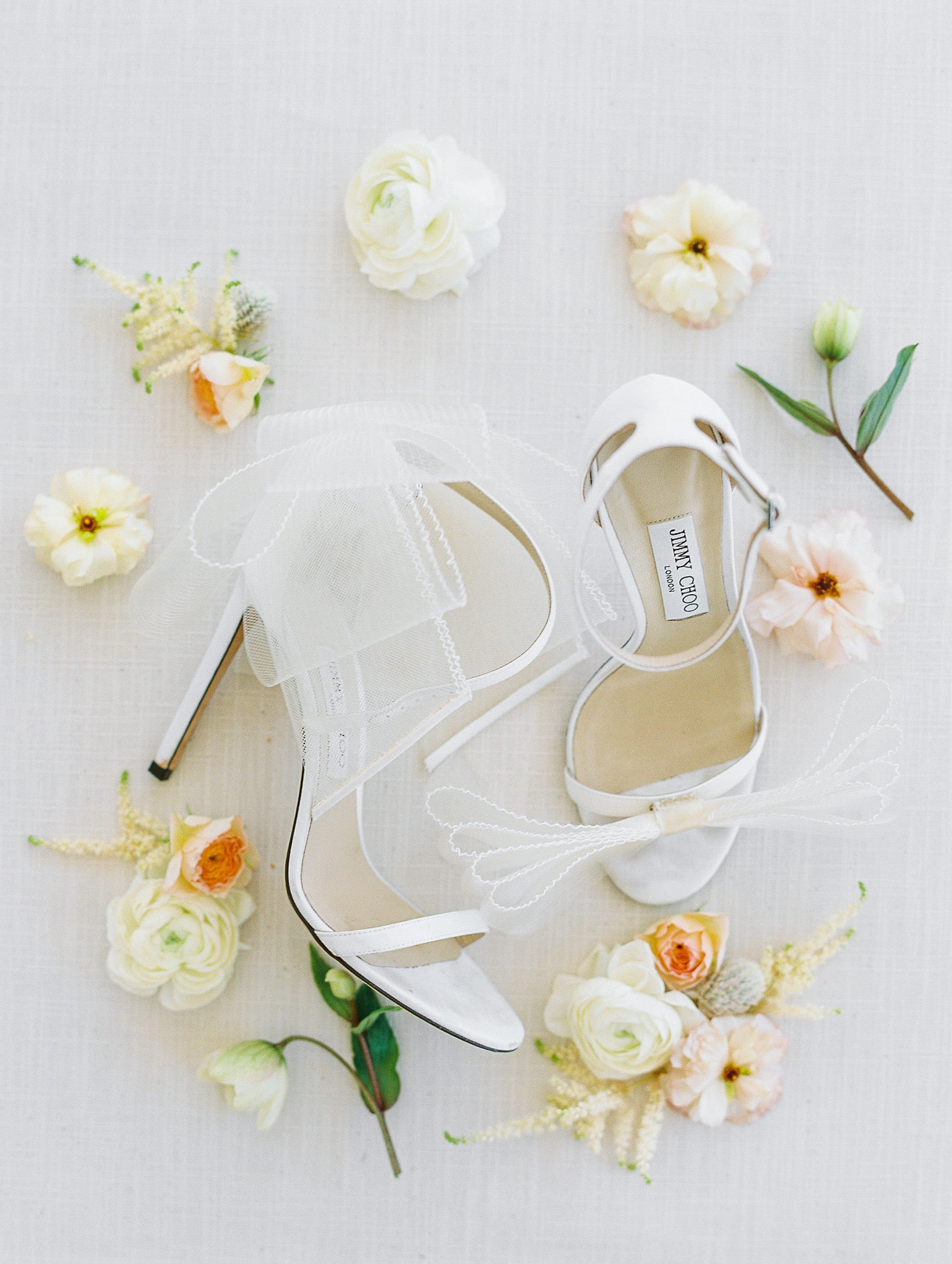 White high heels with ribbons and cream and pink flowers for Clifton wedding photography