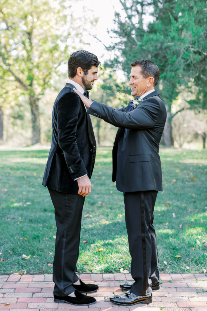 Groom and father smile and freshen up outside before wedding for Clifton wedding photography