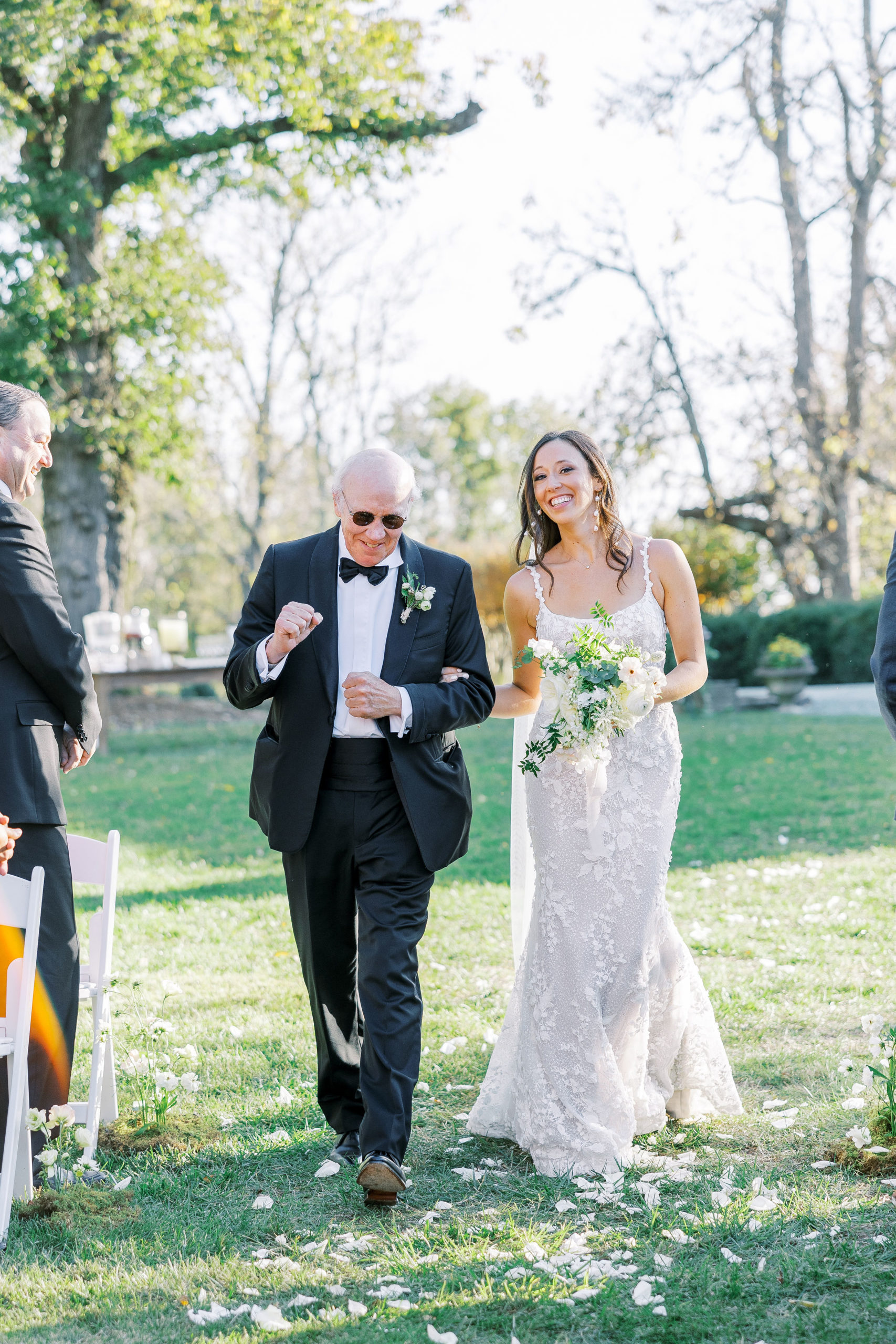 Bride walks down the aisle smiling holding arm of father for wedding for Clifton wedding photography