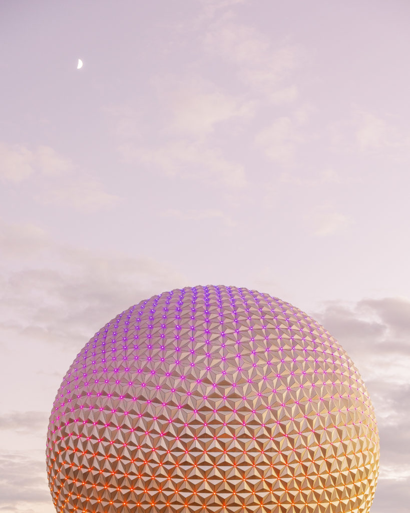 Disney's Epcot silver glowing ball of orange, pink, and red at sunset for California Grill Wedding