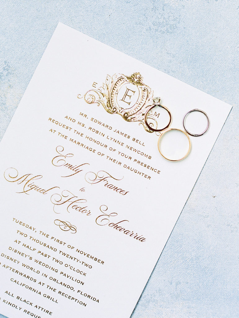 Wedding invitations that are ivory with gold embossed calligraphy and wedding rings for California Grill Wedding