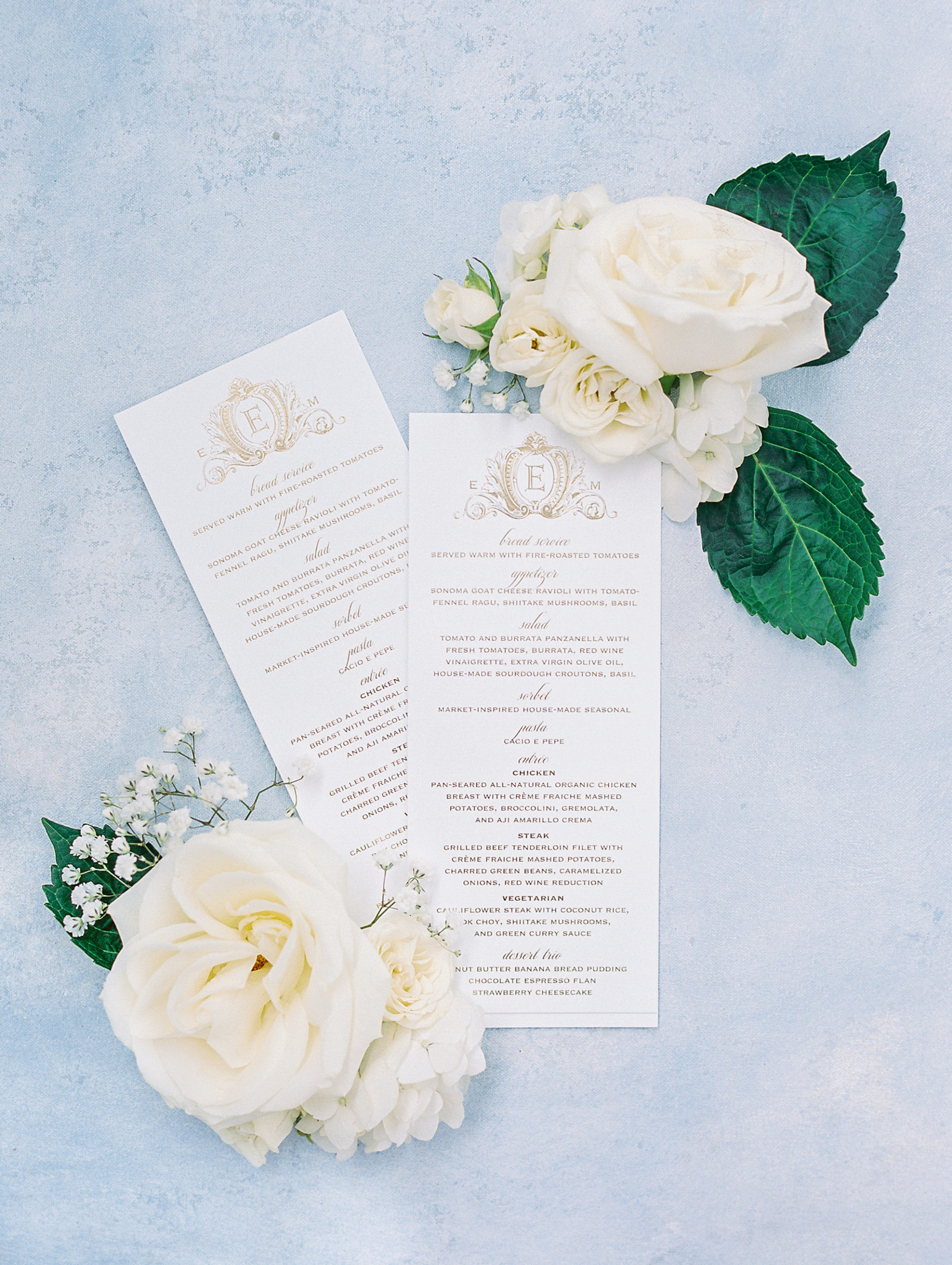 Reception menu with golden embossed calligraphy with white roses for California Grill Wedding 