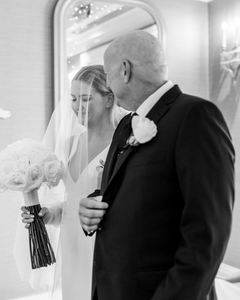 Bride and father start to walk down the aisle and smile 