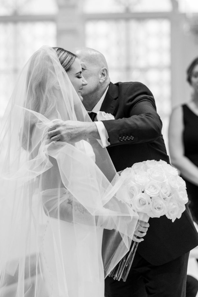 Father of the bride kisses daughter's cheek and takes veil off 