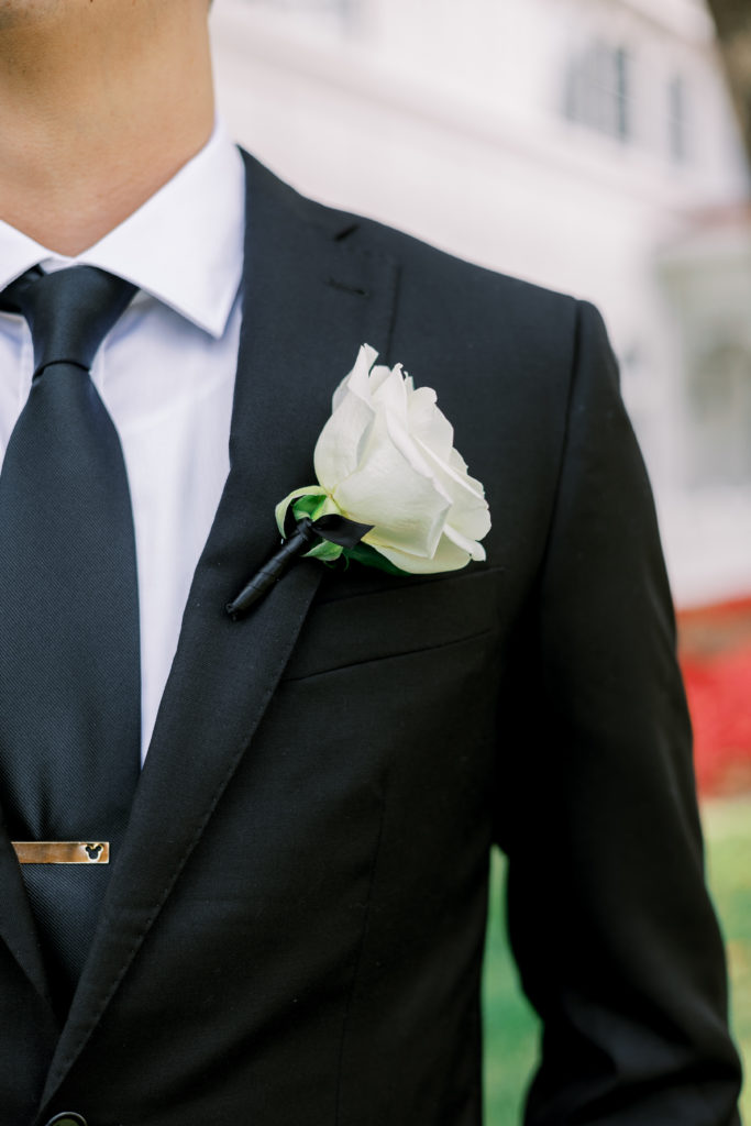 Up close view of groom's black suit and white boutonniere for Disney Film Wedding Photographer 
