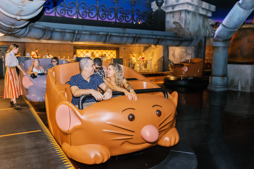 Couple smiles and sits in mouse ride at Disney for California Grill Wedding