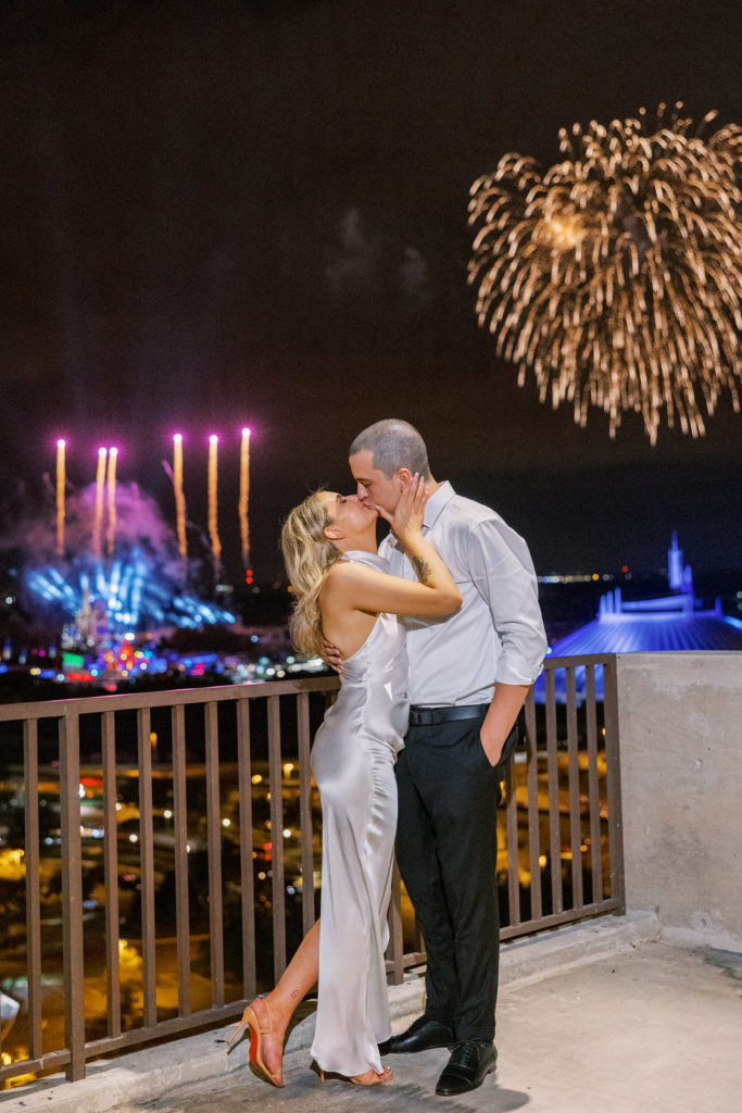 Bride and groom kiss during fireworks at Disney for wedding reception for California Grill Wedding