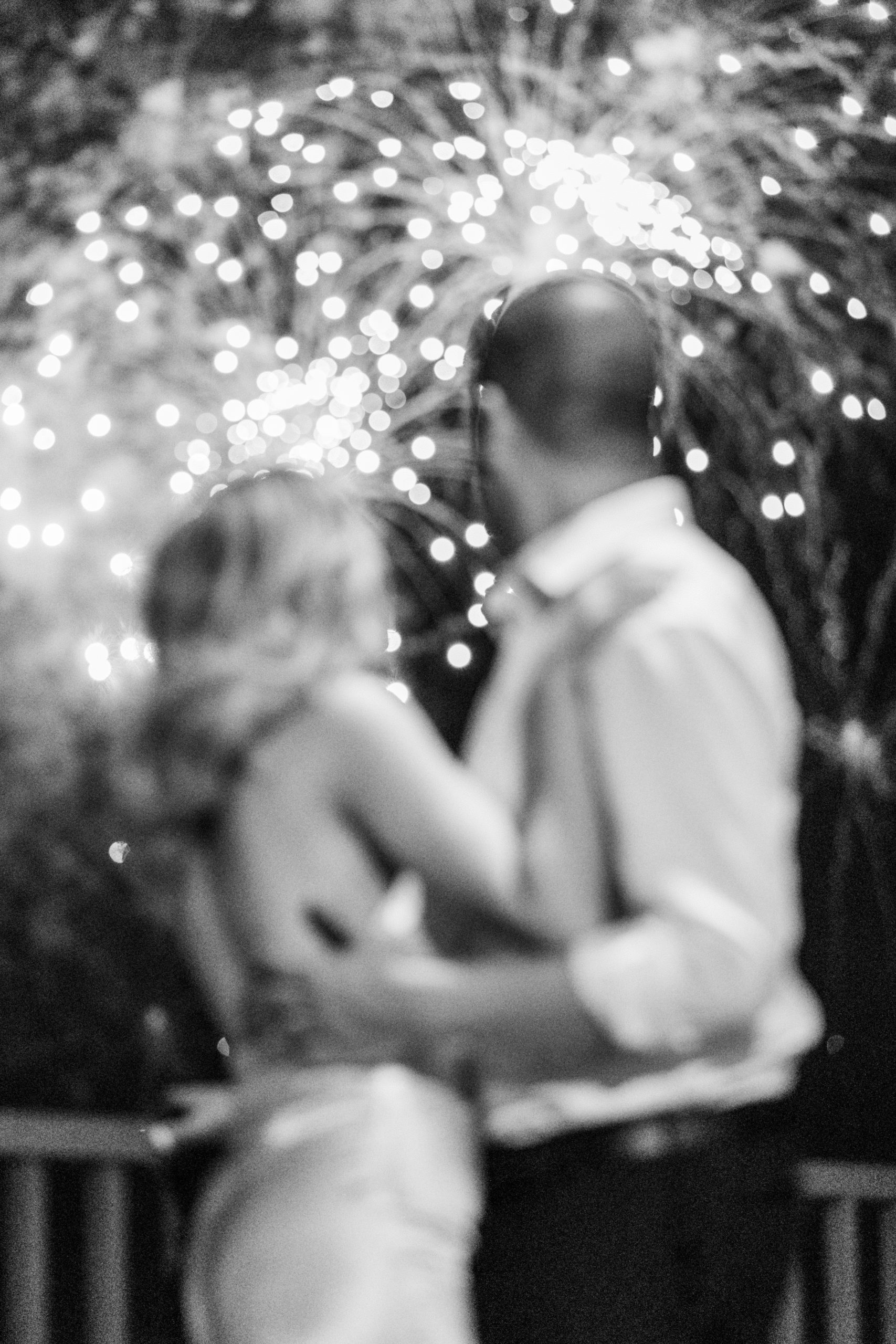 Black and white photo of bride and groom watching fireworks from balcony for California Grill Wedding