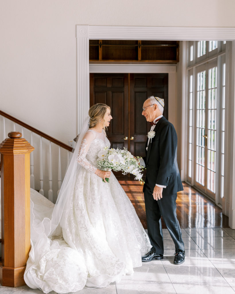 Bride meets with father and they smile for Luxmore Grande Wedding