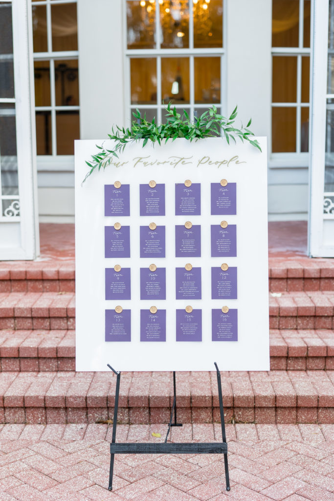 Reception tables and seating chart in purple cards that reads "our favorite people" for Luxmore Grande Wedding