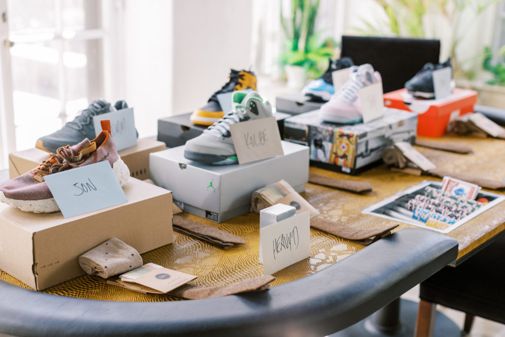 Sneakers on top of boxes with envelope for each groomsmen and ties for philadelphia wedding photographer