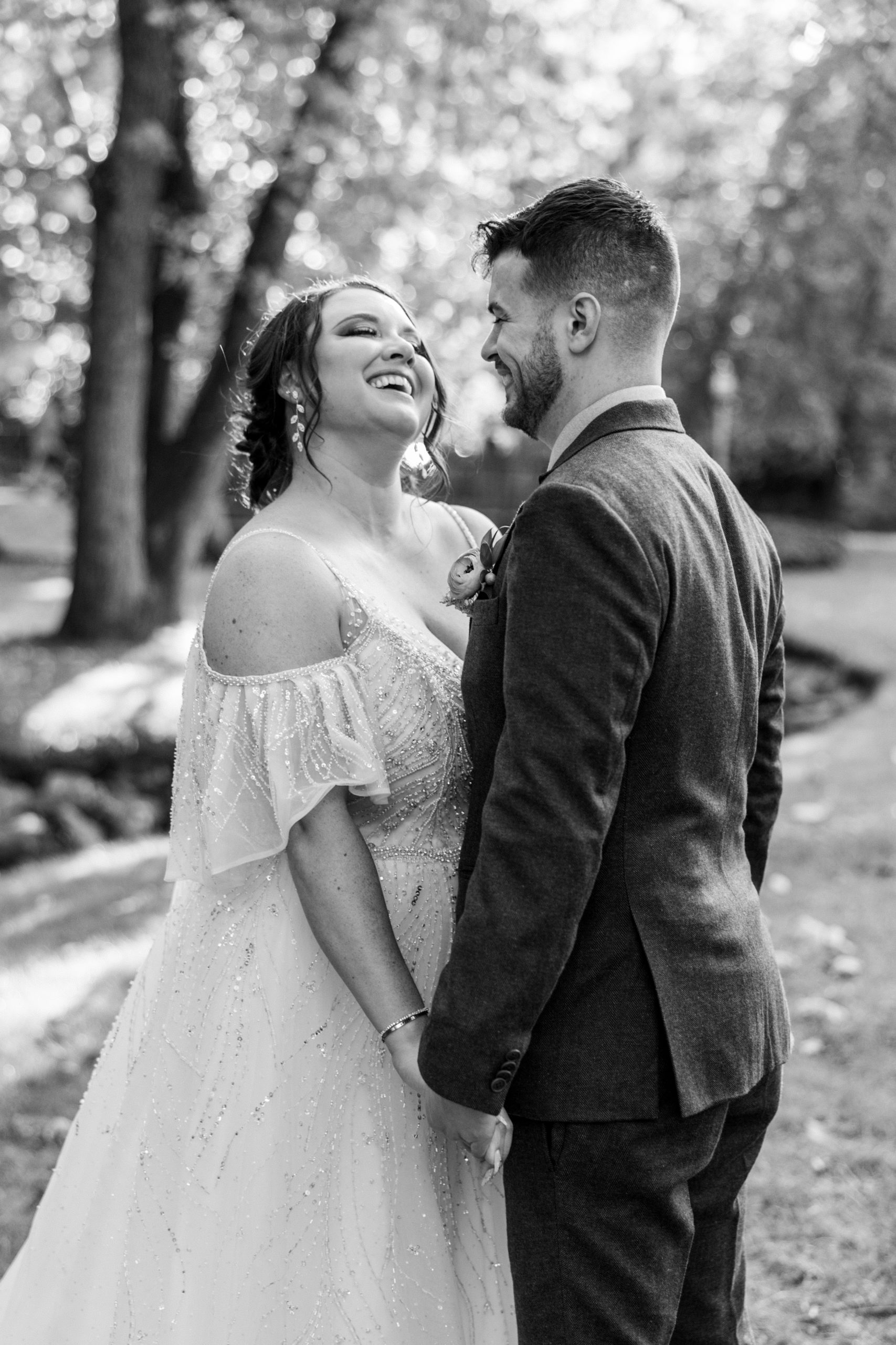 Bride and groom hold hands and smile at each other for philadelphia wedding photographer
