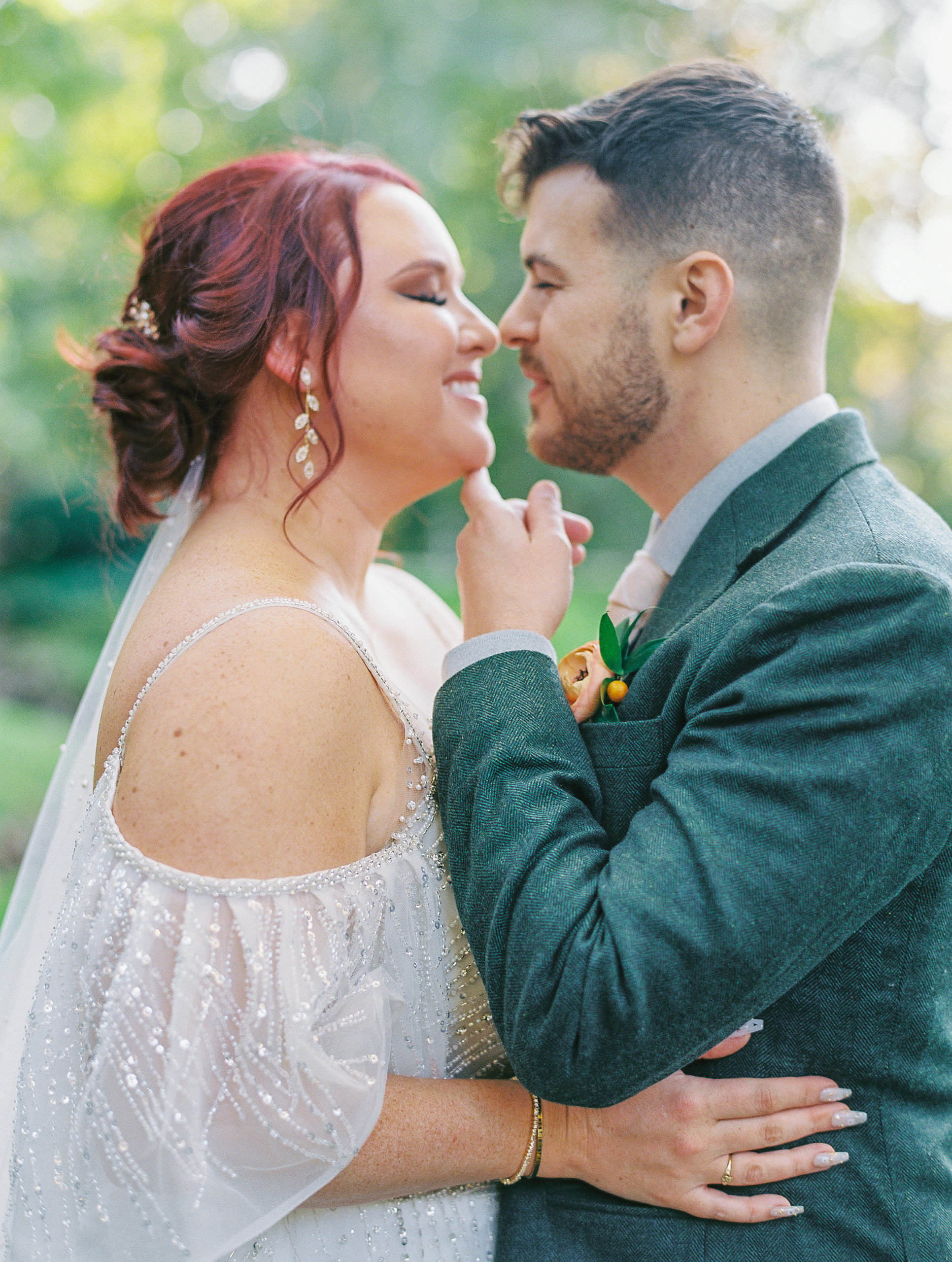 Groom pulls bride in for a kiss with finger under her chin at this pomme radnor wedding