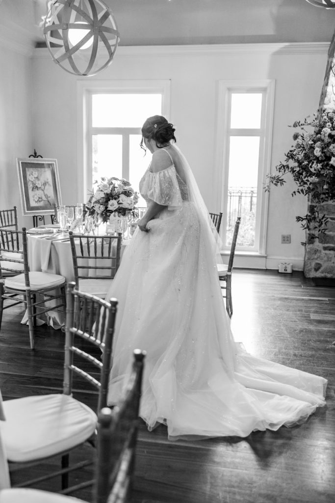 Bride looks at wedding reception tables 