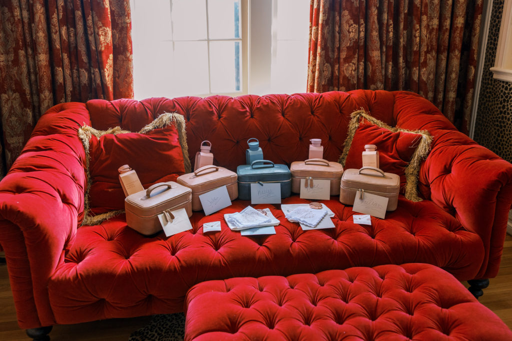 Red velvet couch with bridesmaids boxes and letters for philadelphia wedding photographer